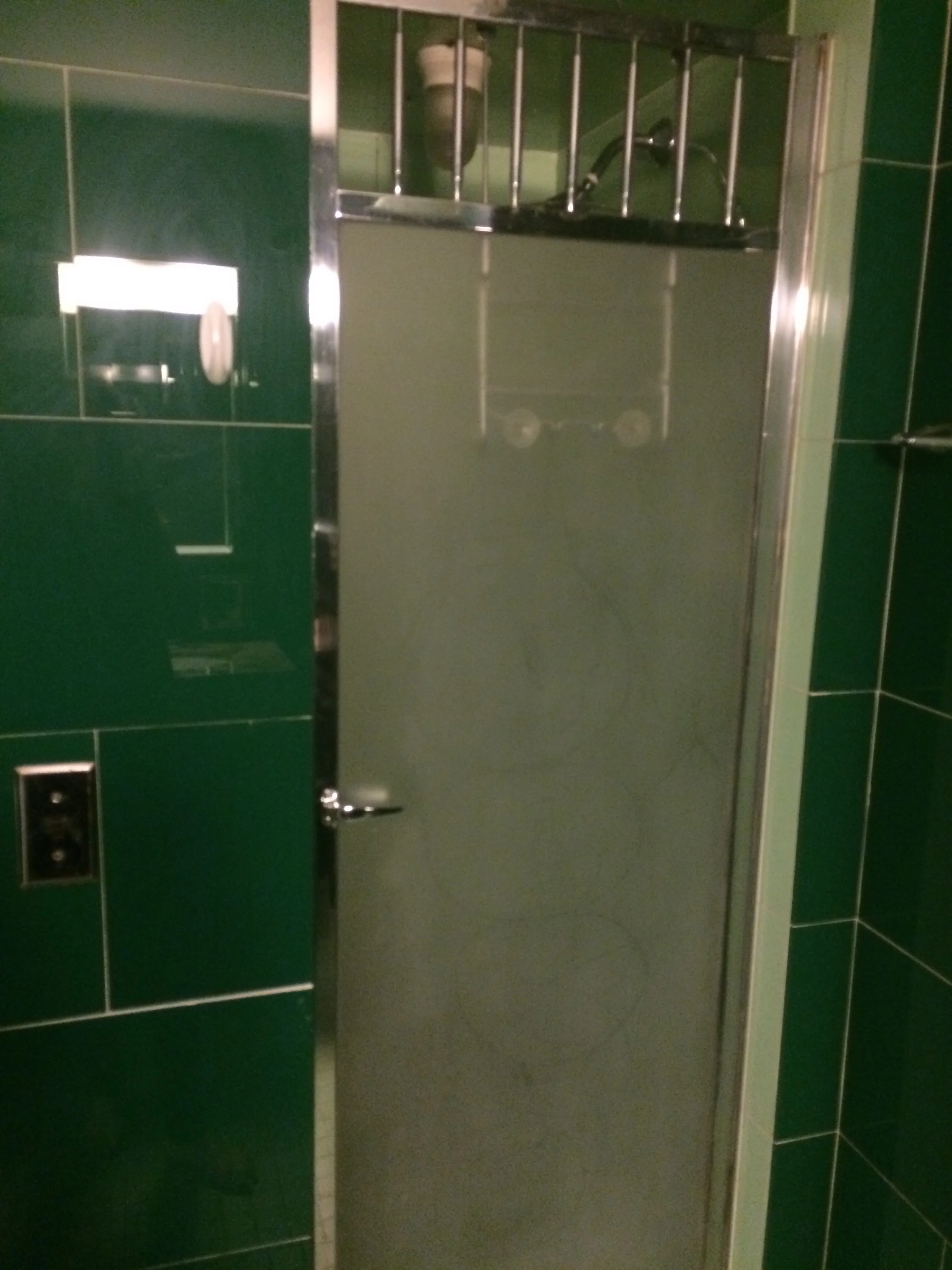 Entry to the tight shower stall (with prison bars at the top, in case you tried to escape?).