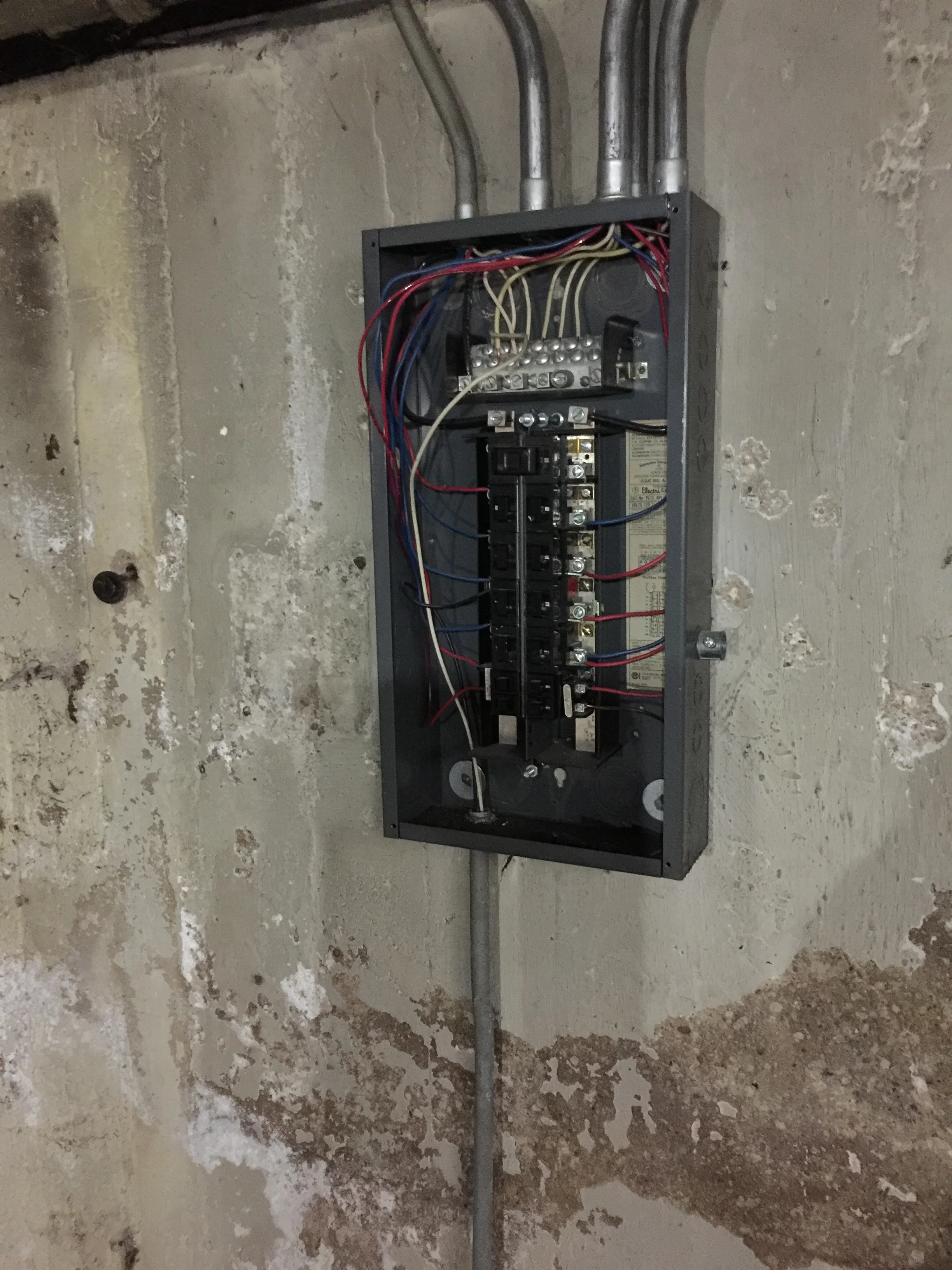 The old electric panel. We are upgrading to 200 amp service with an underground connection to the street (no wires hanging above the front lawn). 