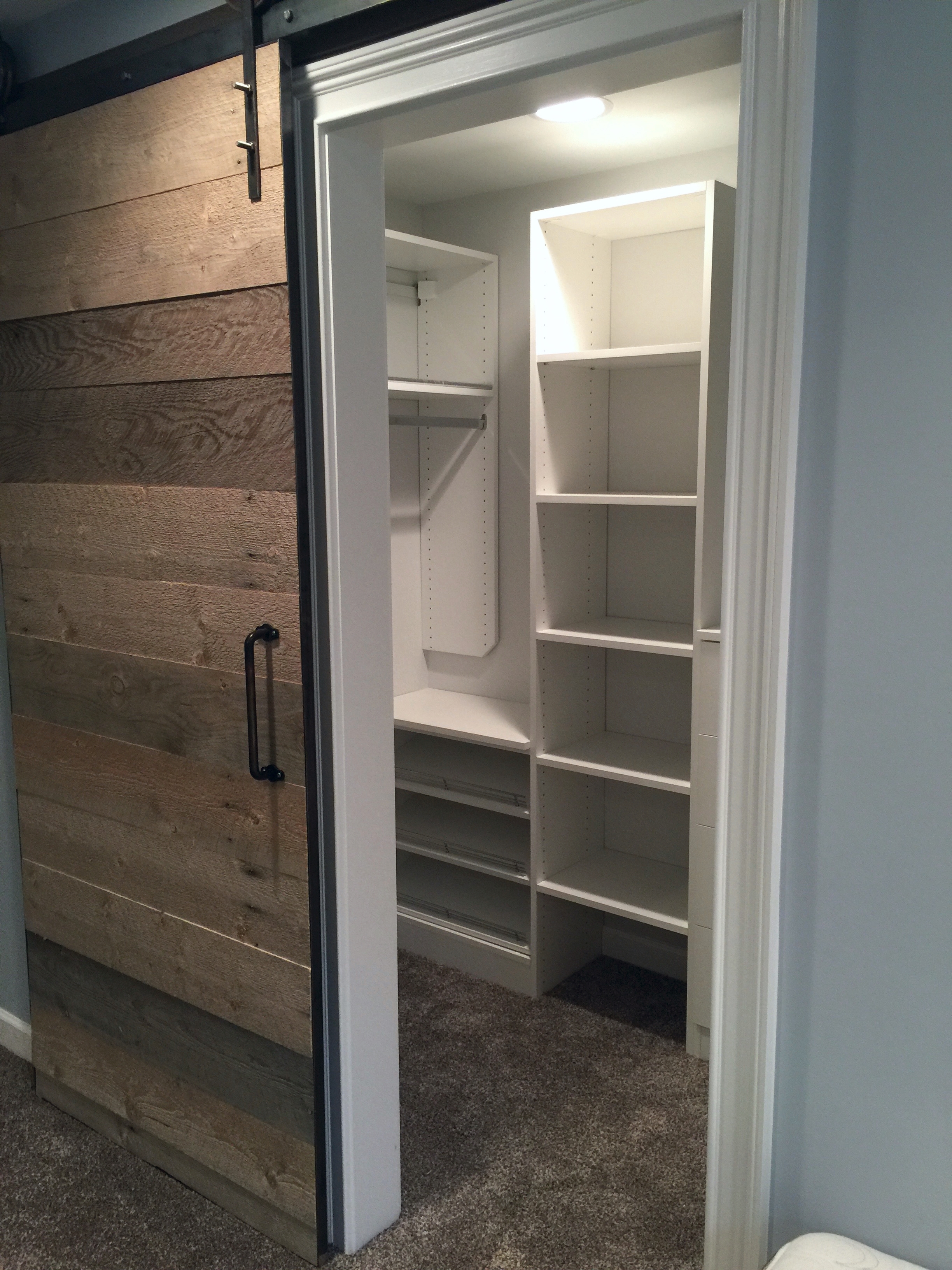The basement bedroom closets are accessed by custom barn doors made in Utah. 
