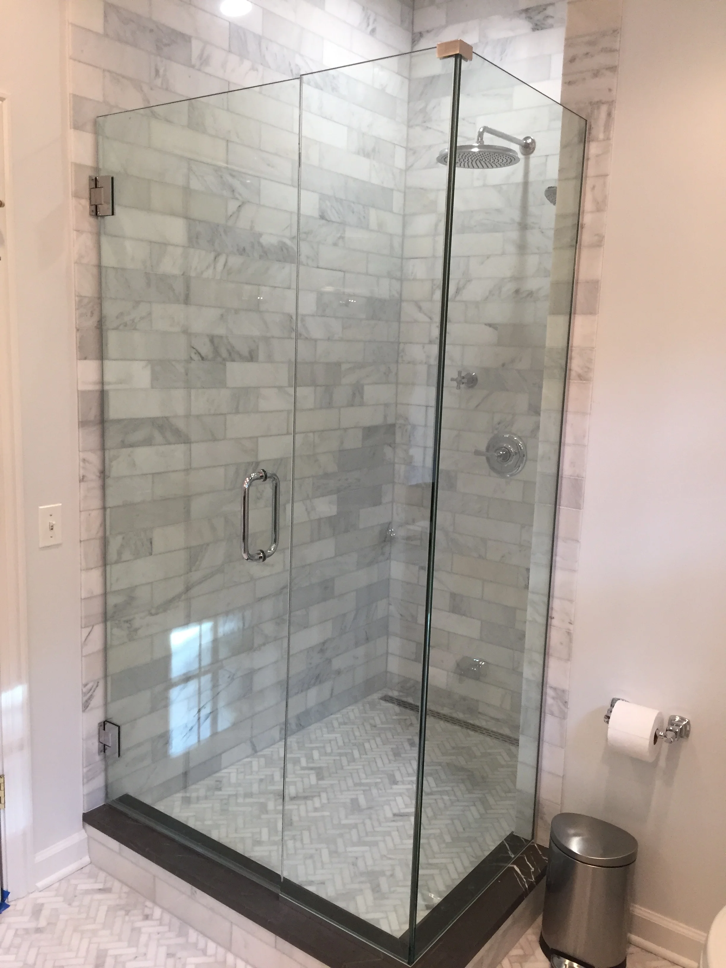 At what height should the shower head be placed? Tall owners require taller than average placement, so it's a good idea to stand in the shower before setting the final plumbing position. 
