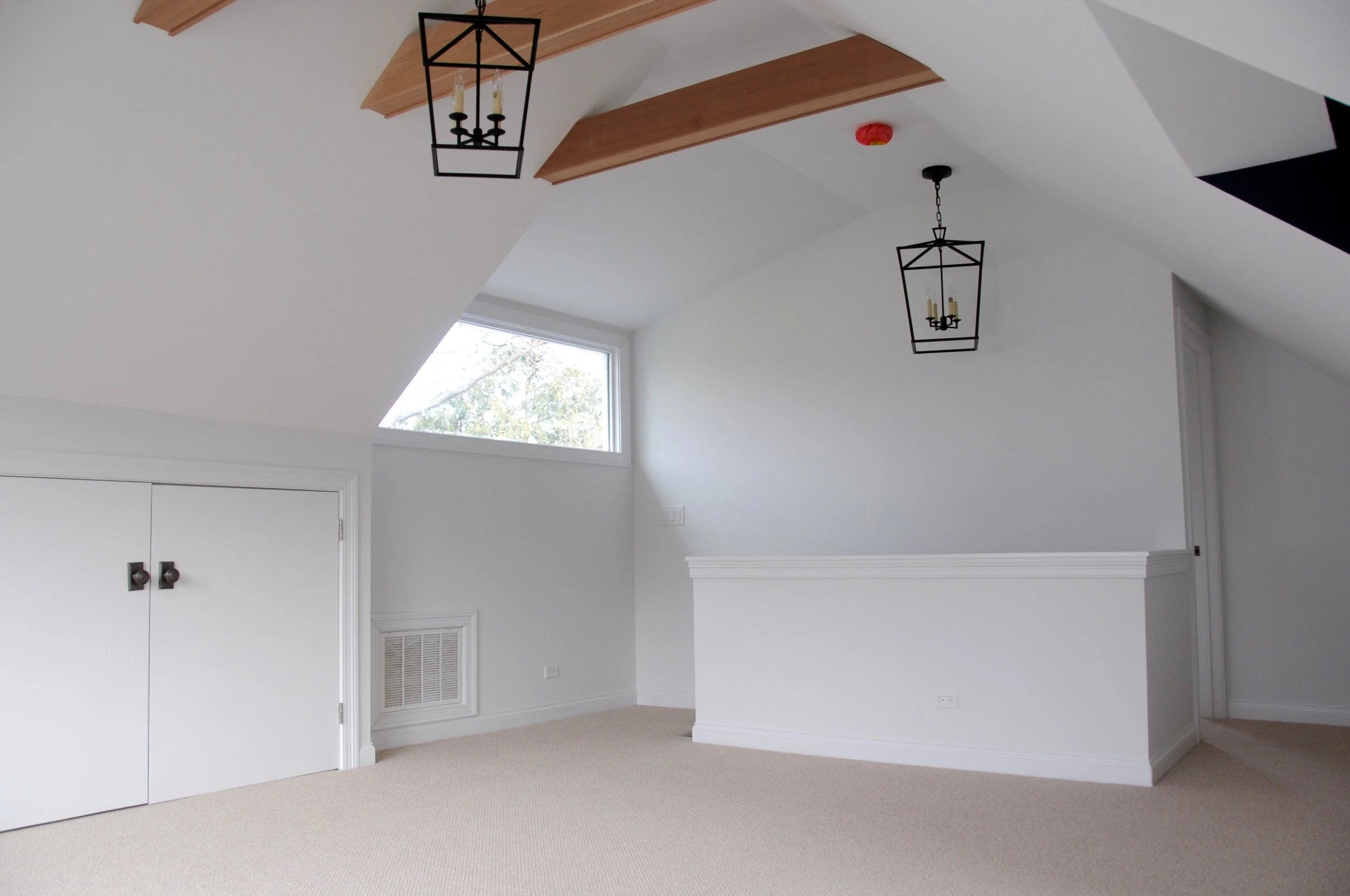 The air-handler is now running efficiently in an enclosed space behind the two short doors, and the stairs are behind the half-wall under the lantern light. The view of the locust tree from the new picture window gives you the feeling of floating among the trees, so we named this attic space "the treehouse." One of our daughters decided it most closely resembles a "fairy castle." Despite my limited experience with fairy castles, I'm okay running with that, too. 