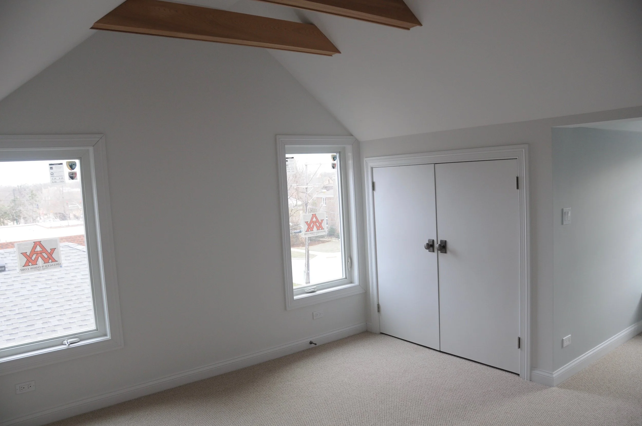 The adjacent bedroom with closet and new windows. This room is flooded with light for most of the day and has its own reading bench in the dormer.