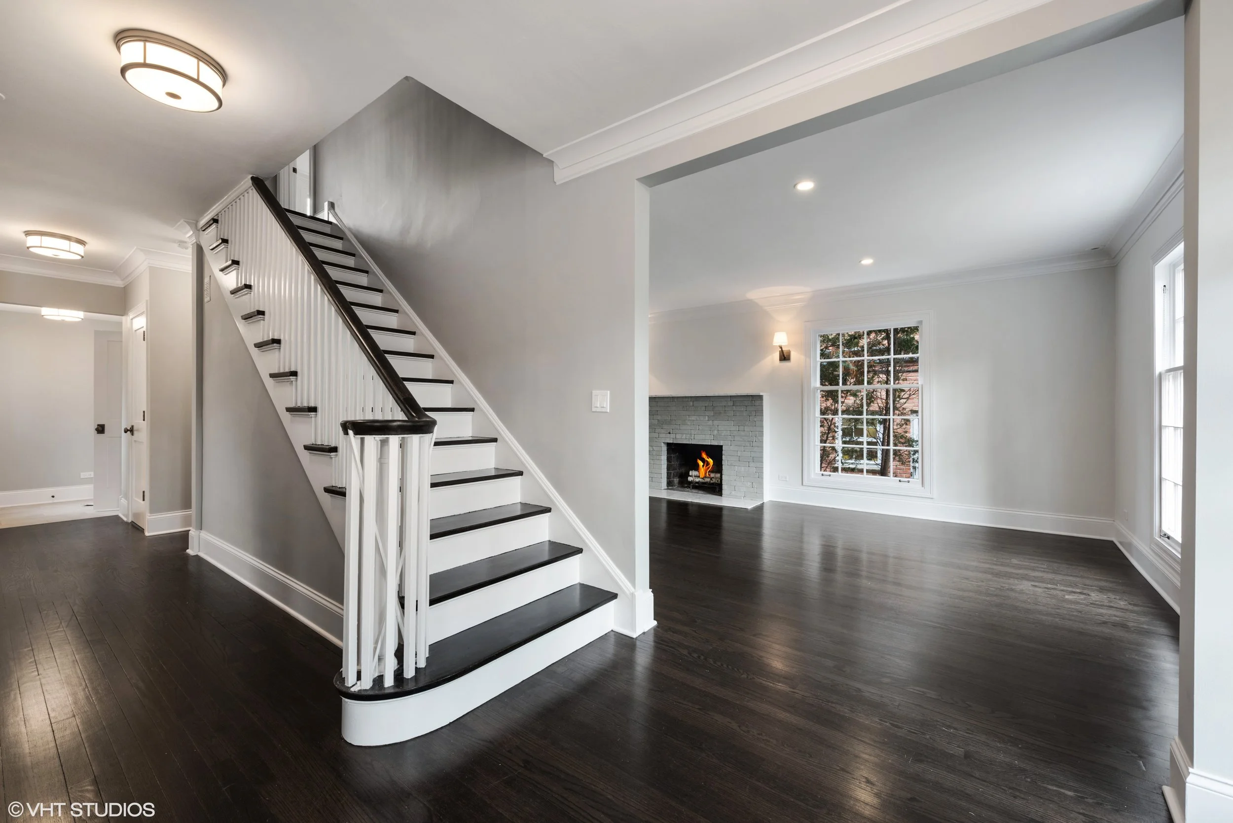 We refinished the hardwood floors with a custom stain, replaced the baseboard, and installed crown molding. The traditional center entry stairwell was stabilized and reinforced.