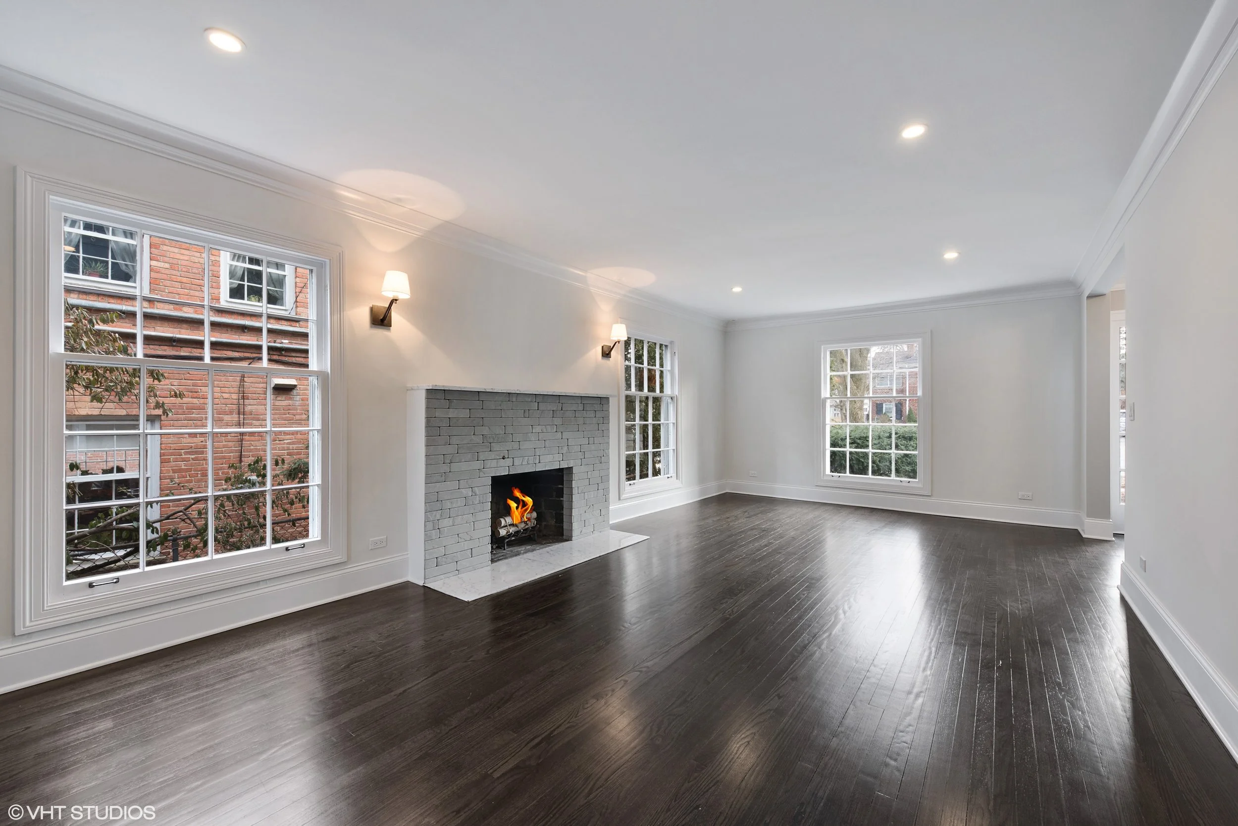 The typically oversized living room is always a bit tricky in colonial homes of this age, but we added lighting to complement the natural light from the large windows and refinished the fireplace which had previously featured painted brick. 