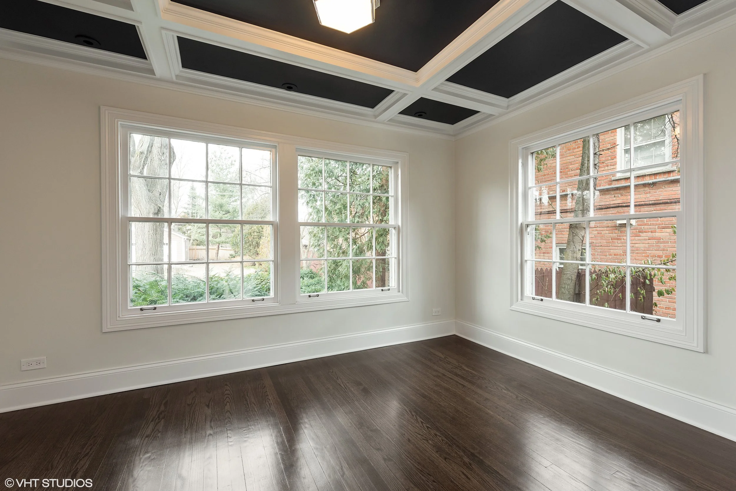 Another view of the study. The tightly compartmentalized floor plans of older homes are often incompatible with how families live today, so it's common to merge small spaces that are closed off and divide other spaces that are unusually large. 