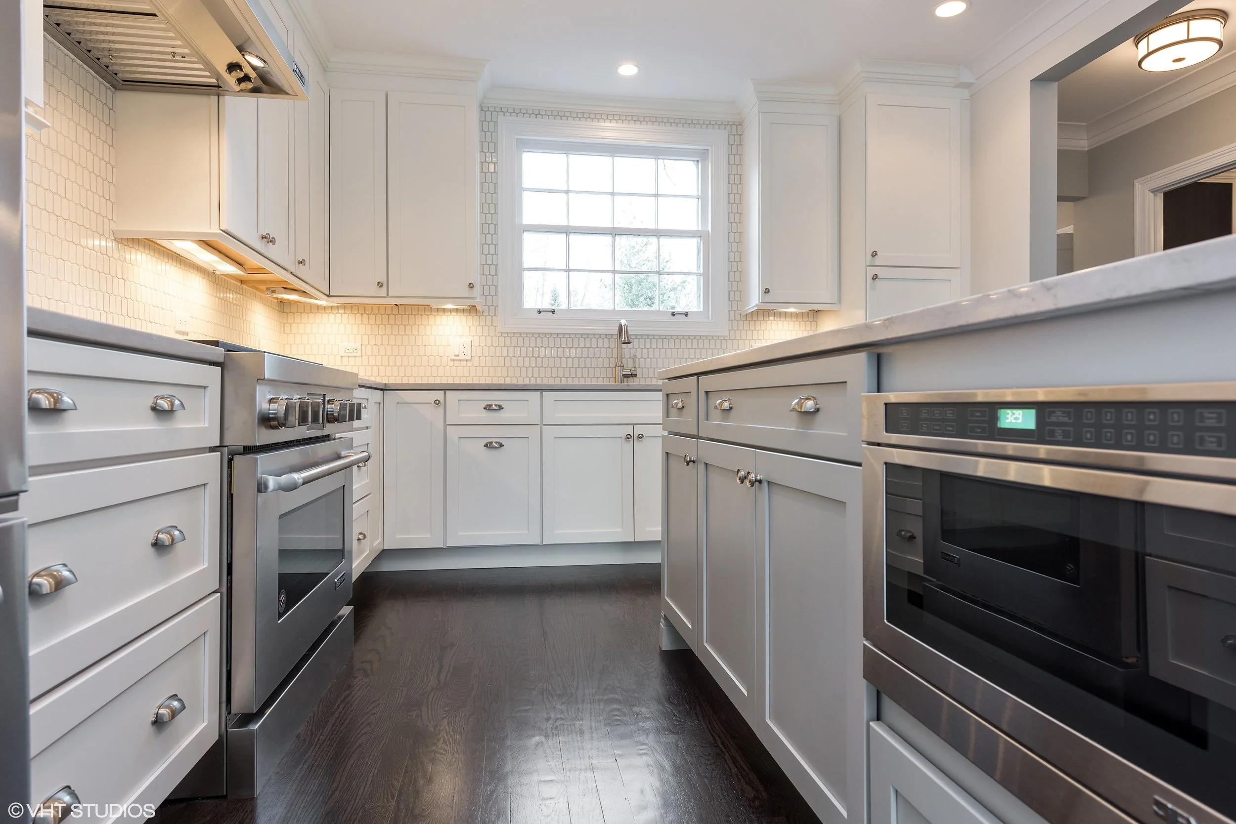 A good layout is vital because so much of family life occurs in or near the kitchen. If possible, we like to make kitchens comfortable for two or more people to work together. Pathway widths of 44" between range and island and 46" between sink and island are shown here. An eight foot island ensures plenty of counter space for food prep and seating for four.