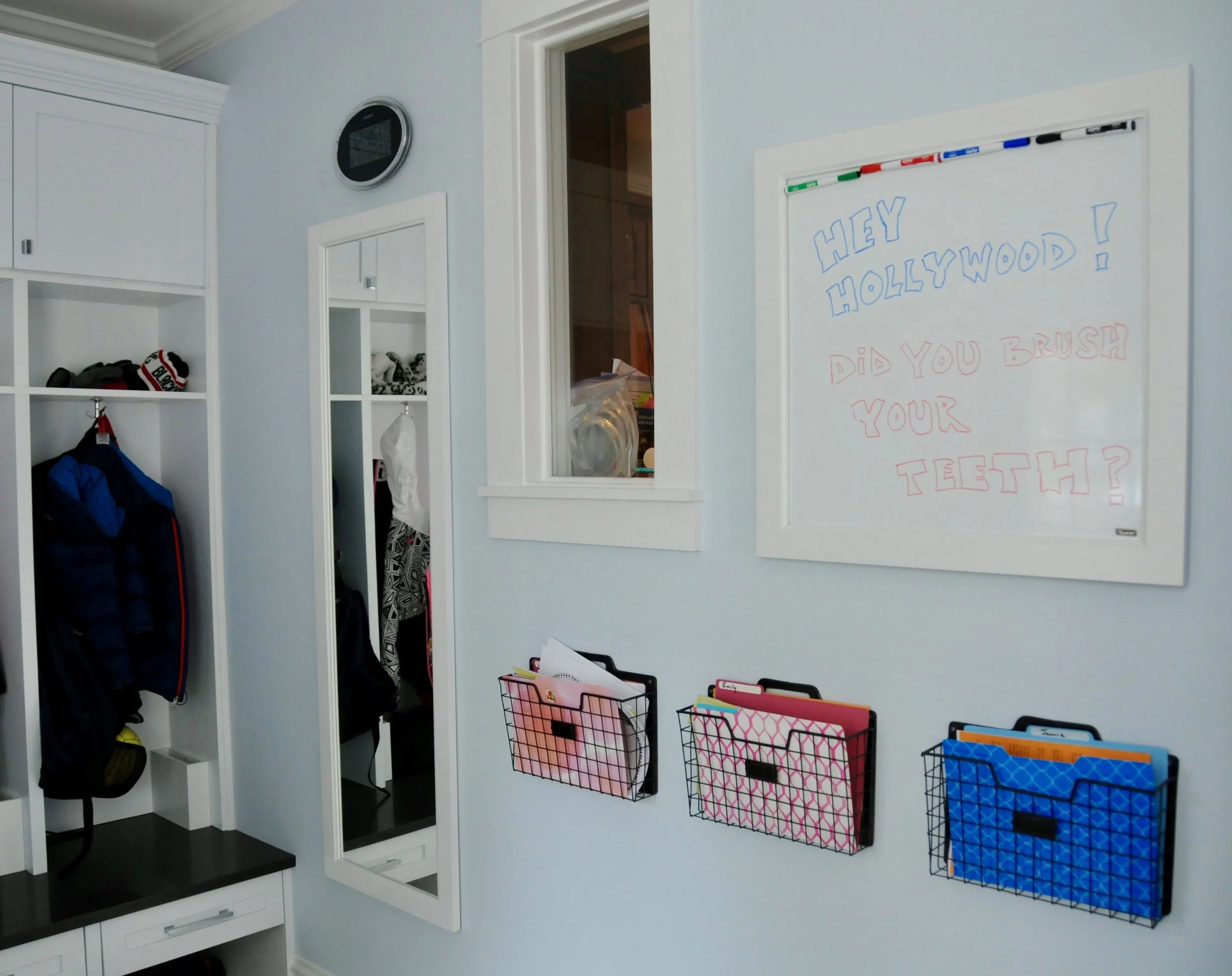 We framed the mirror and white board to match the cabinetry, each child has a school basket, and the whiteboard is a convenient messaging companion to all of the devices in our digital world. 