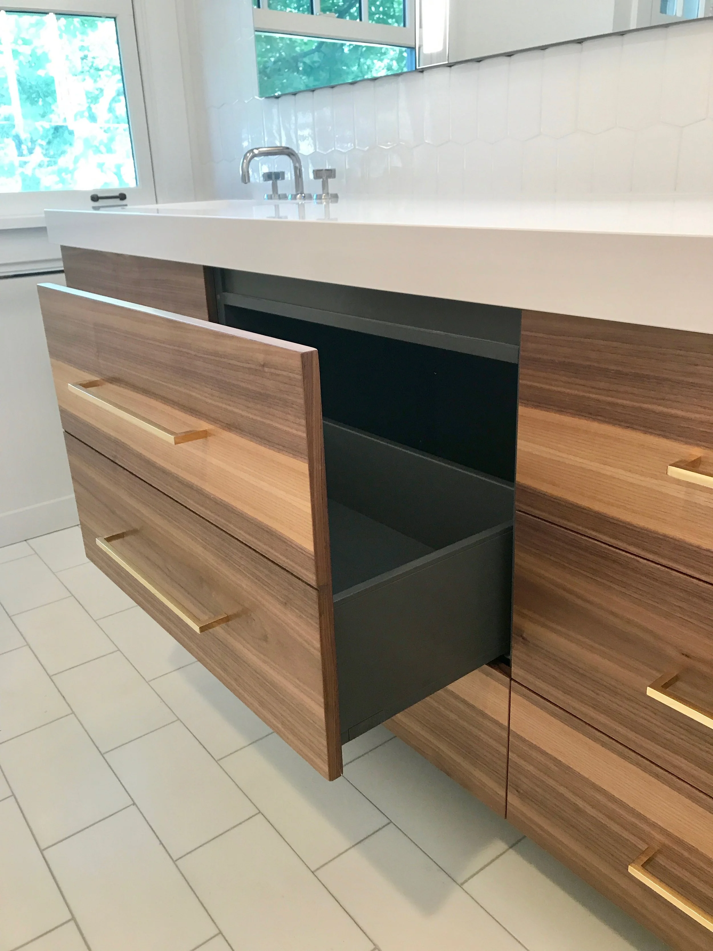The middle section was designed for extra depth to hold bath towels. All drawers are functional.