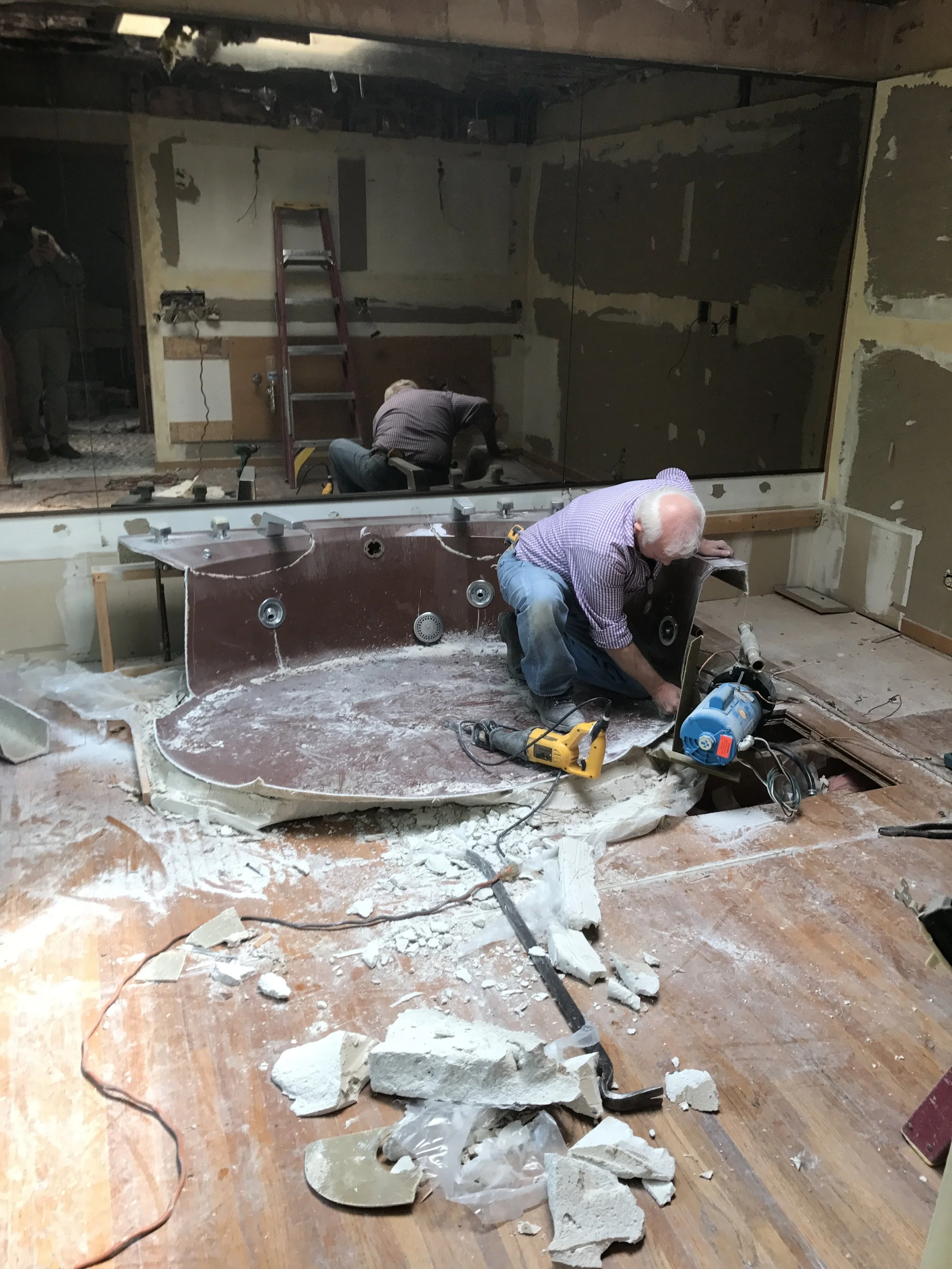 Check out the full wall of smoky mirrored glass for ambience. Farewell, carpet and tub. We had to use a reciprocal saw to take you out in pieces. We'll always have these pictures and the marketing brochure for memories. 
