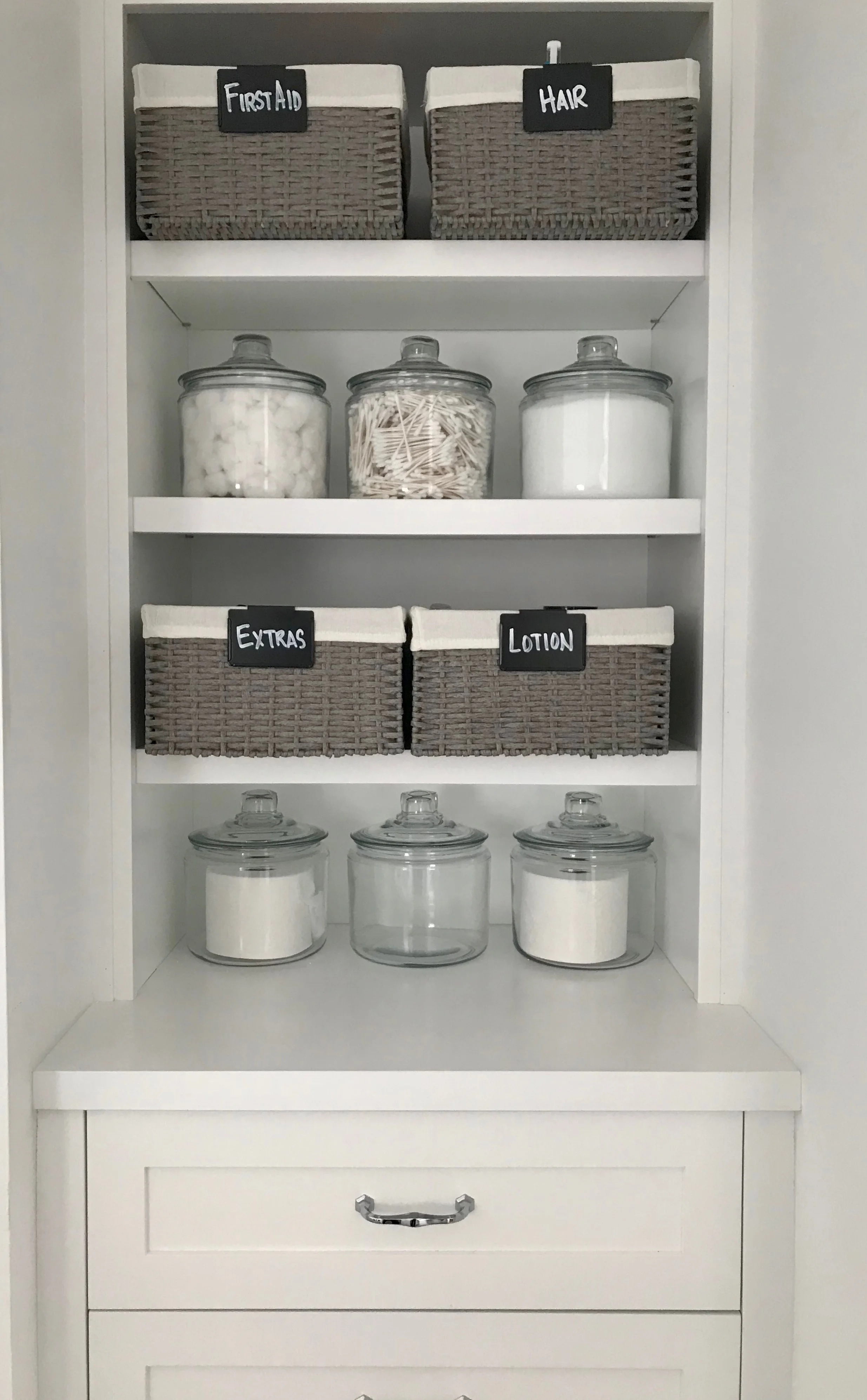 Efficient storage is one key to a successful bathroom project. Here, we installed custom inset cabinetry with drawers and open storage on both sides of the bathroom entry.
