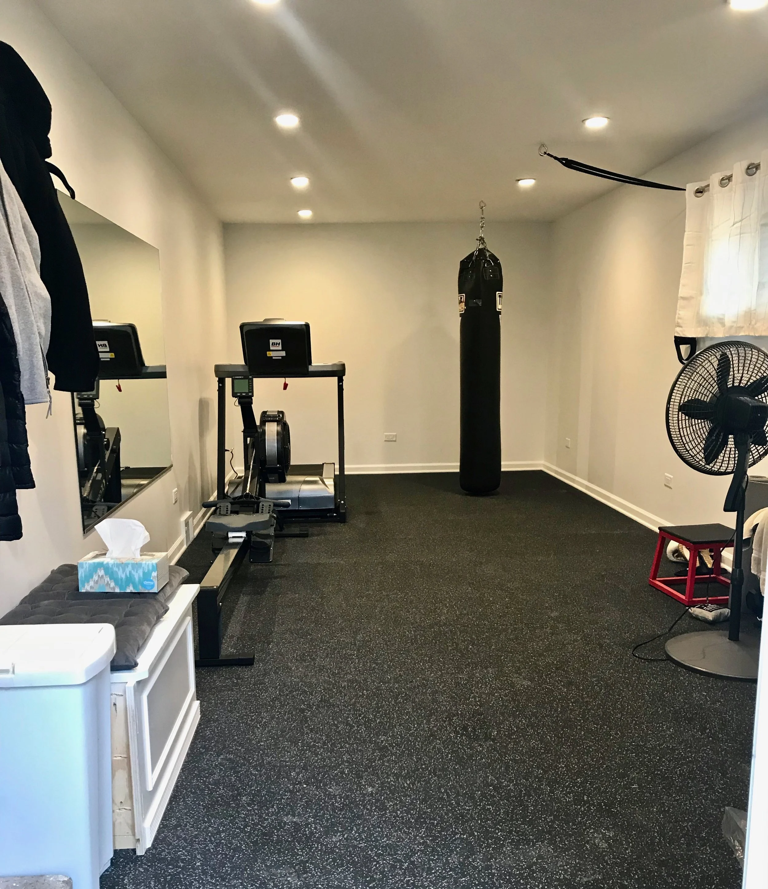 The former garage comfortably holds a treadmill, rowing machine, heavy bag, TRX system, and more, all on a 3/4” thick rubberized floor. No more excuses for skipping a workout when you have this attached to your home.