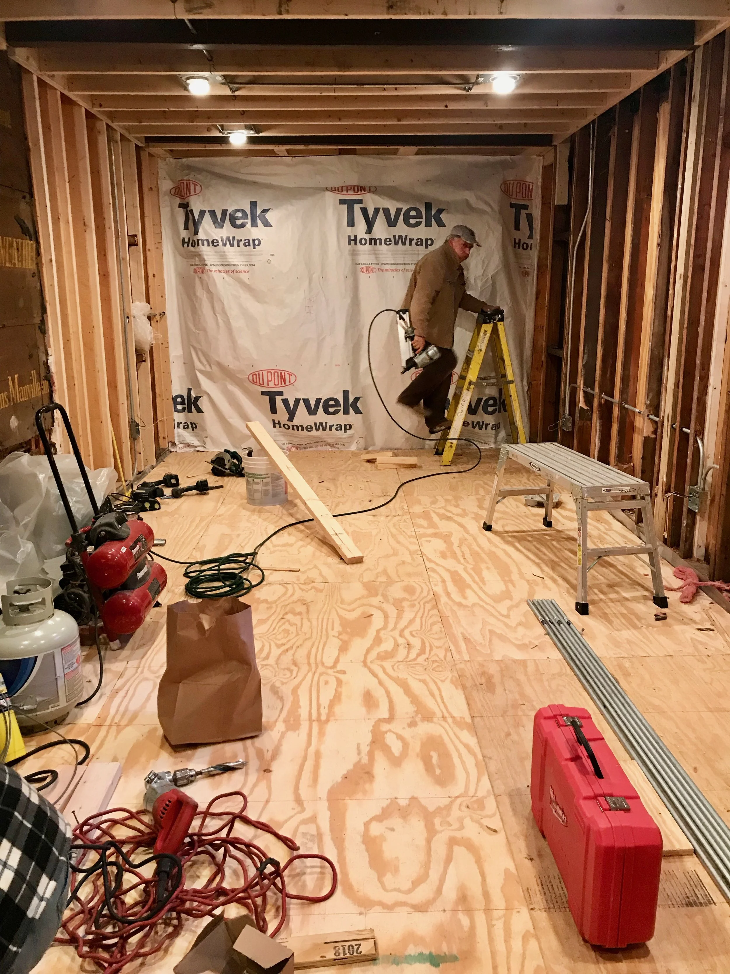 Under the 3/4” plywood sub-floor is a vapor barrier, stud platform, and closed cell foam insulation. A minor amount of disassembly and demolition would be required to revert to a functional garage in the future.