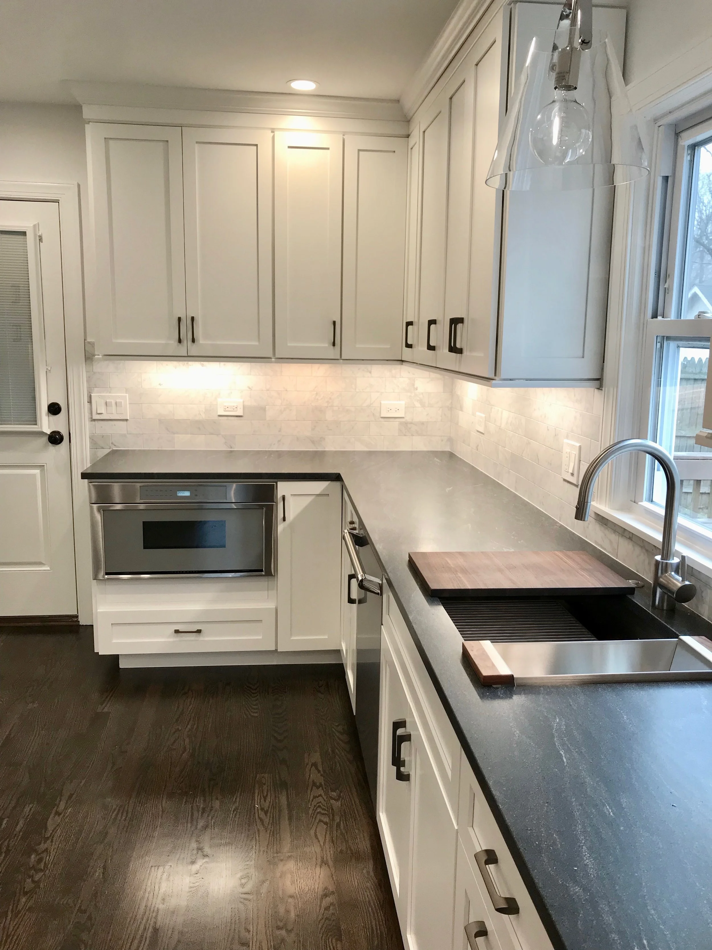 The new kitchen features Thermador appliances , a multi-function sink, and honed granite countertops.