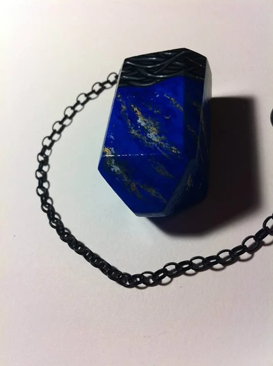 Handcarved wooden divination pendulum with painted lapis faux finish and painted setting design.
