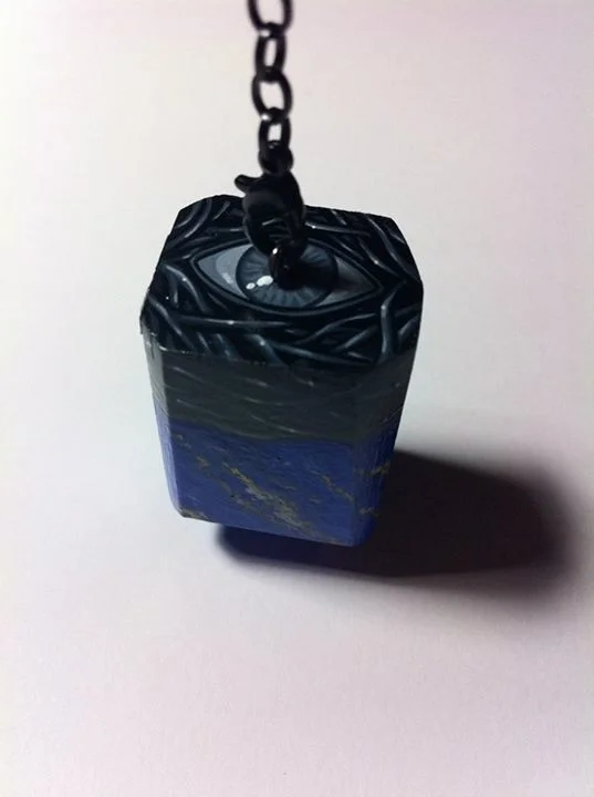 Handcarved wooden divination pendulum with painted lapis faux finish and painted setting design.