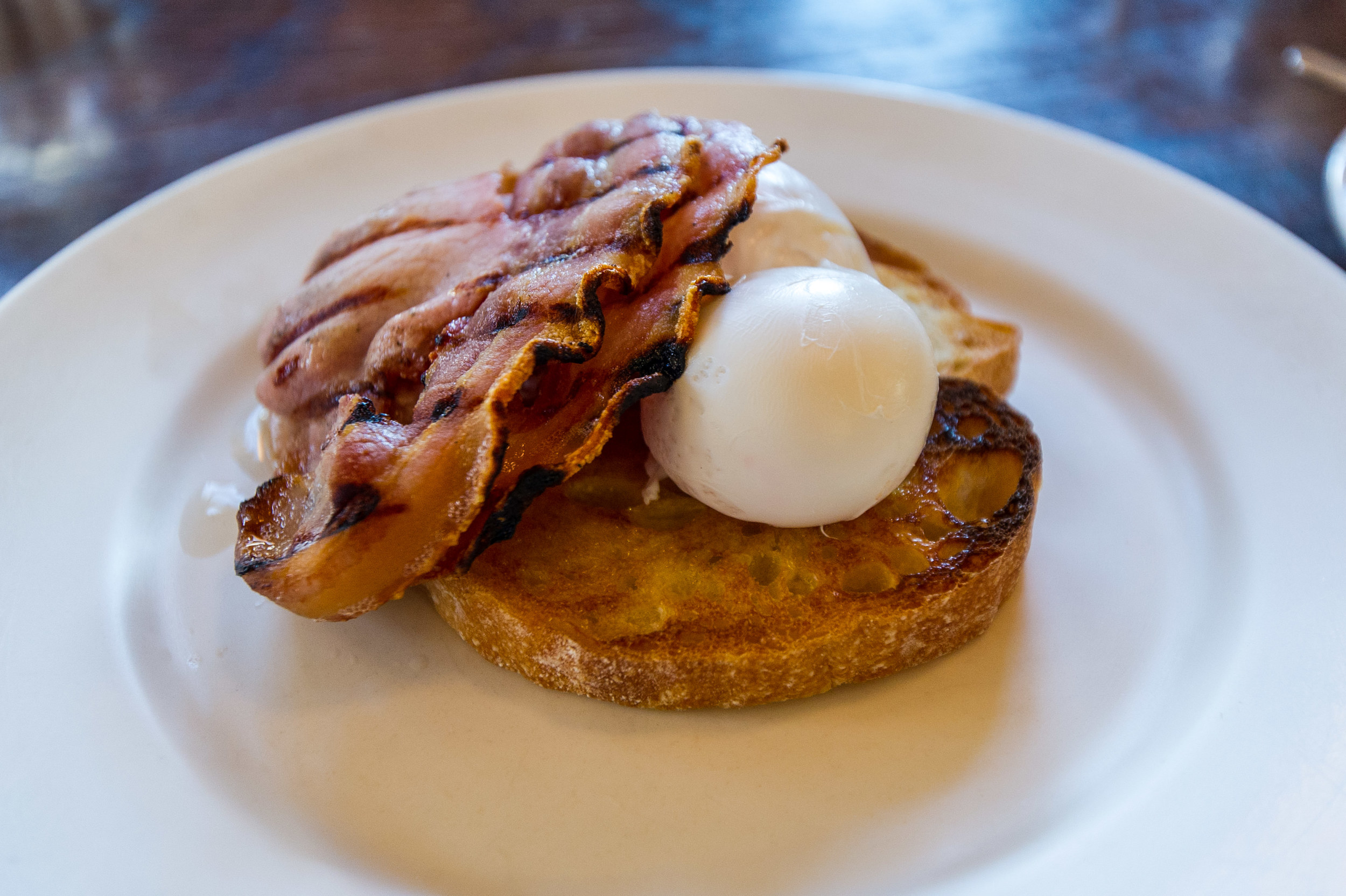 Poached eggs and streaky bacon served on toast at Floriditas in Wellington.