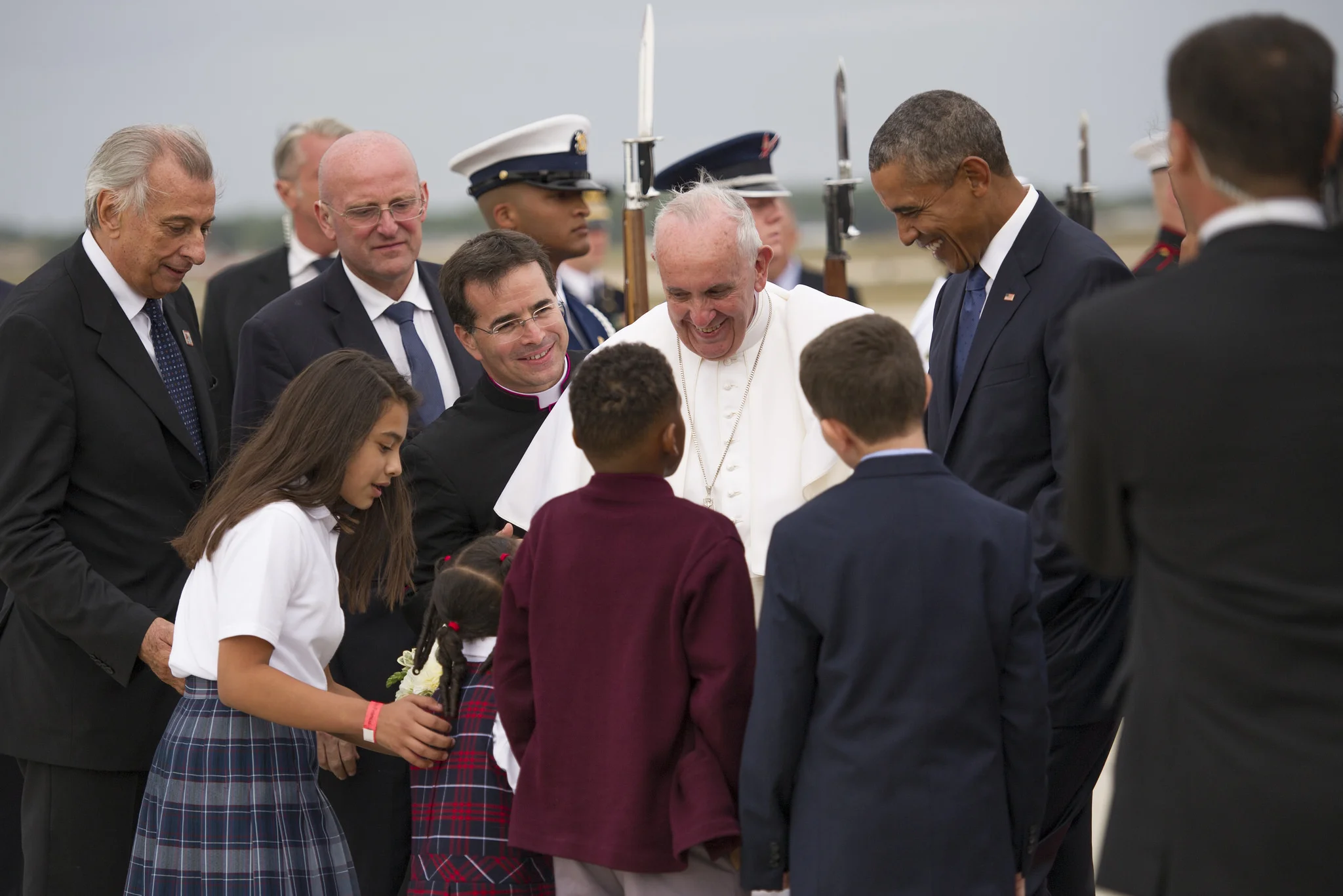 Pope Francis and President Barack Obama are greeted by Catholic school children on the flightline at Joint Base Andrews, Md., Sept. 22. The children are local to the National Capital Region and presented the pope with a gift of flowers. (U.S. Air Force Photo/Tech. Sgt. Robert Cloys)