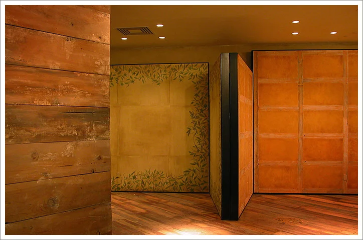 Vignette Walls: Left wall: Hand painted floral design on burlap. Right wall: Venetian Plaster. Anthropologie store. St Louis, Missouri.