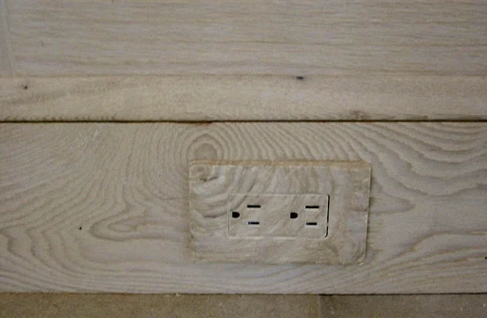 Faux wood outlet to blend existing wood on baseboard.