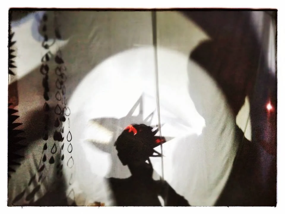 Shadow Sail Theatre A portable shadow theatre that hosts workshops in shadow puppet crafting by day and an interactive shadow playground by night. Multiple overhead projector stations set up with puppets, found materials, and shadow masks are designed to invoke audience participation in the creation of an eclectic, all inclusive shadow jam. Shadow Sail Theatre was supported in part by the Burning Man Global Art Grant and Bellingham’s Sustainable Connections Kapow! Placemaking Grant.