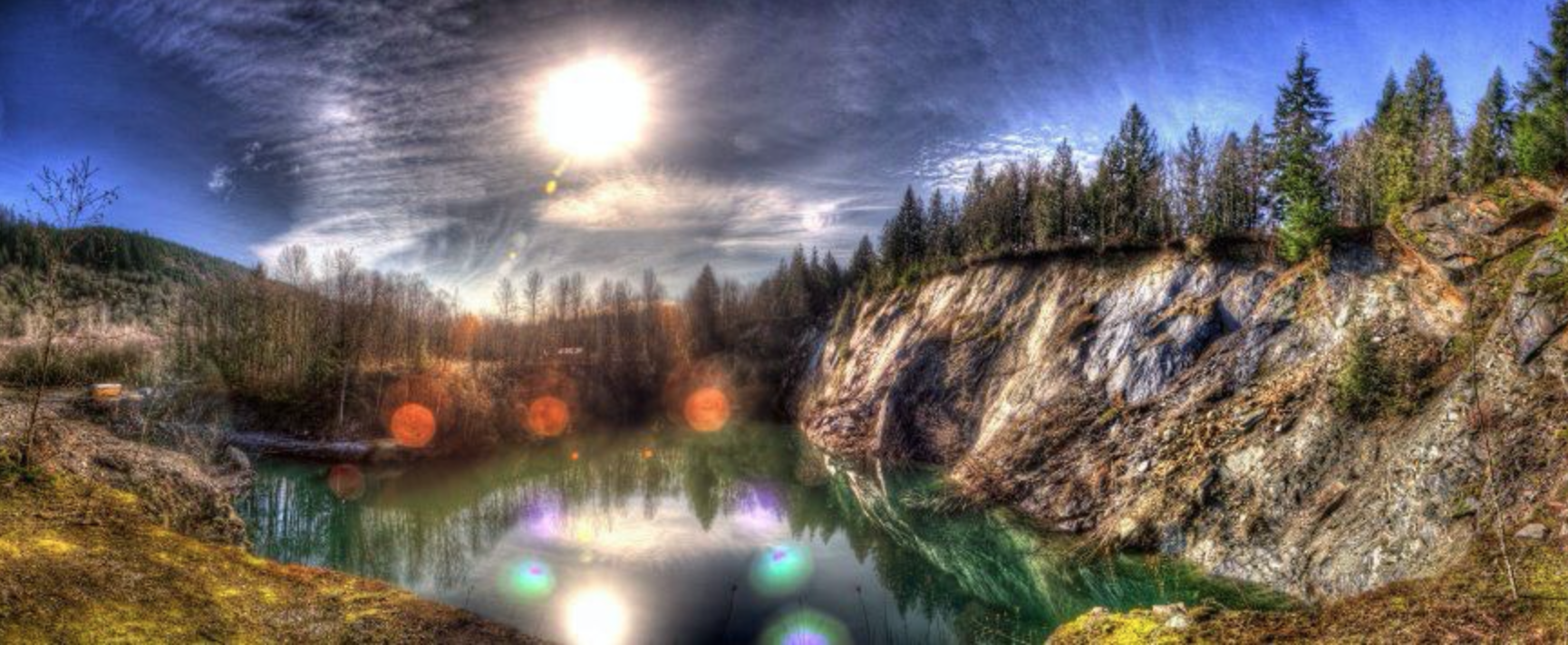The Lookout Arts Quarry Sparks Designs' home base is the Lookout Arts Quarry in Bellingham WA, a 60 acre rock quarry turned collectively owned permaculture circus and arts center. We consistently dedicate our time and resources to community engaged art practices, environmental sustainability and spreading the network of collaborative artistry. Through ground up sociocratic governing design we’ve built artist facilities including stages, a music studio and sprung floor radiant heat dance studio, installed all of our own utilities including a town sized solar operated water system, run a year round artist in residence program and host seasonal arts education based festivals. We steward both a nature conservation wetland filled with native specie plants and wild birds as well as oversee the care of a river. At the heart of the land is a rain fed 80’ deep lake suspended with slack and zip lines. www.lookoutarts.com