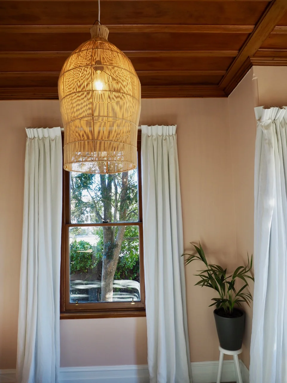 Charmer in Alexandra Master Bedroom Wallpaper Pink Green Pearl Drapes Rattan Pendant Sage Green Linen Lounger - 3.jpg