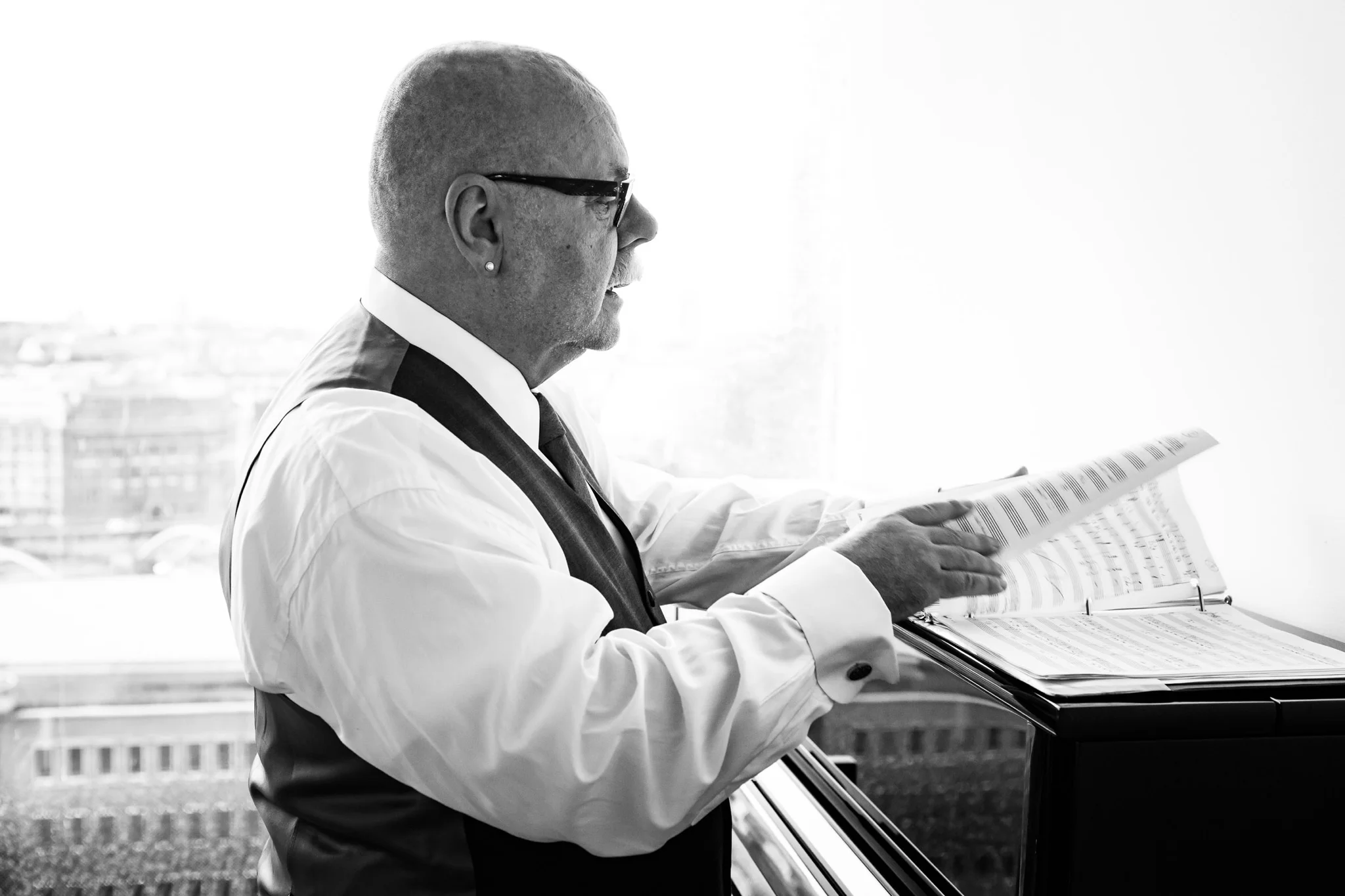 Mark Hummel preparing scores for Hamburg concert at Elbphilharmonie with Rufus Wainwright. Photo Credit: Peter Hundert