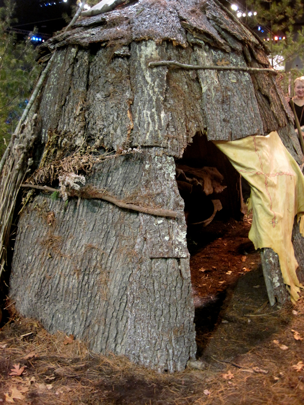 A Native American-inspired bark hut was the focal point of this naturalistic landscape.
