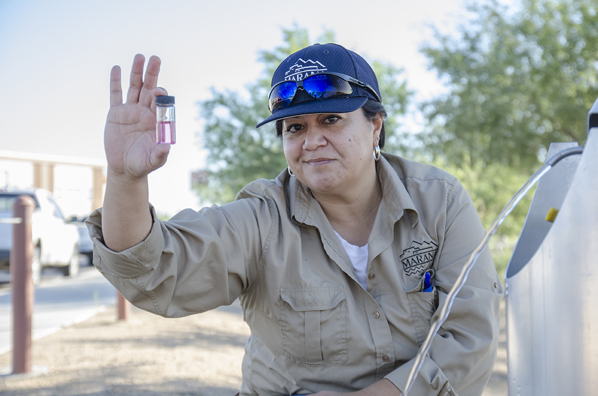 Marana Water's water quality inspector in the field testing the water system.