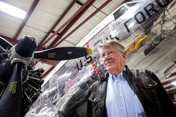 In this March 7, 2016 photo, Karl Stoltzfus, Dynamic Aviation founder and chairman, poses for a photo with his restored DC-3, Miss Virginia, undergoing maintenance inside one of his company's hangars in Bridgewater, Va. Stoltzfus has purchased the plane known as "Air Force One," an aircraft that shuttled President Dwight Eisenhower around the globe, for a bit less than the $1.5 million asking price. (Daniel Lin/Daily News-Record via AP)