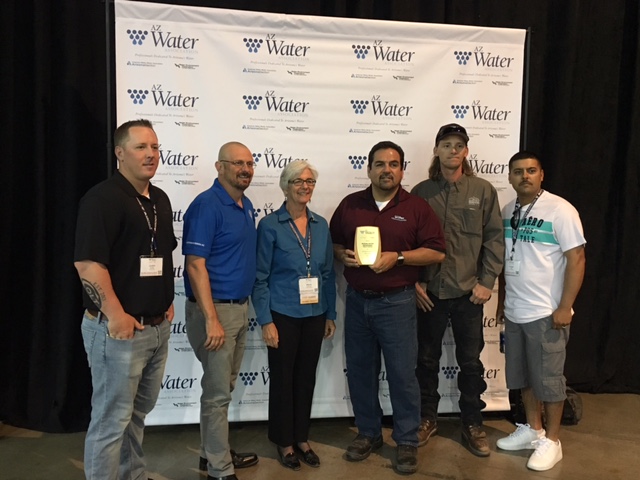 Members of our water distribution team with Director John and AZWater President Marie accepting the award for Water Distribution System of the Year: Small System.
