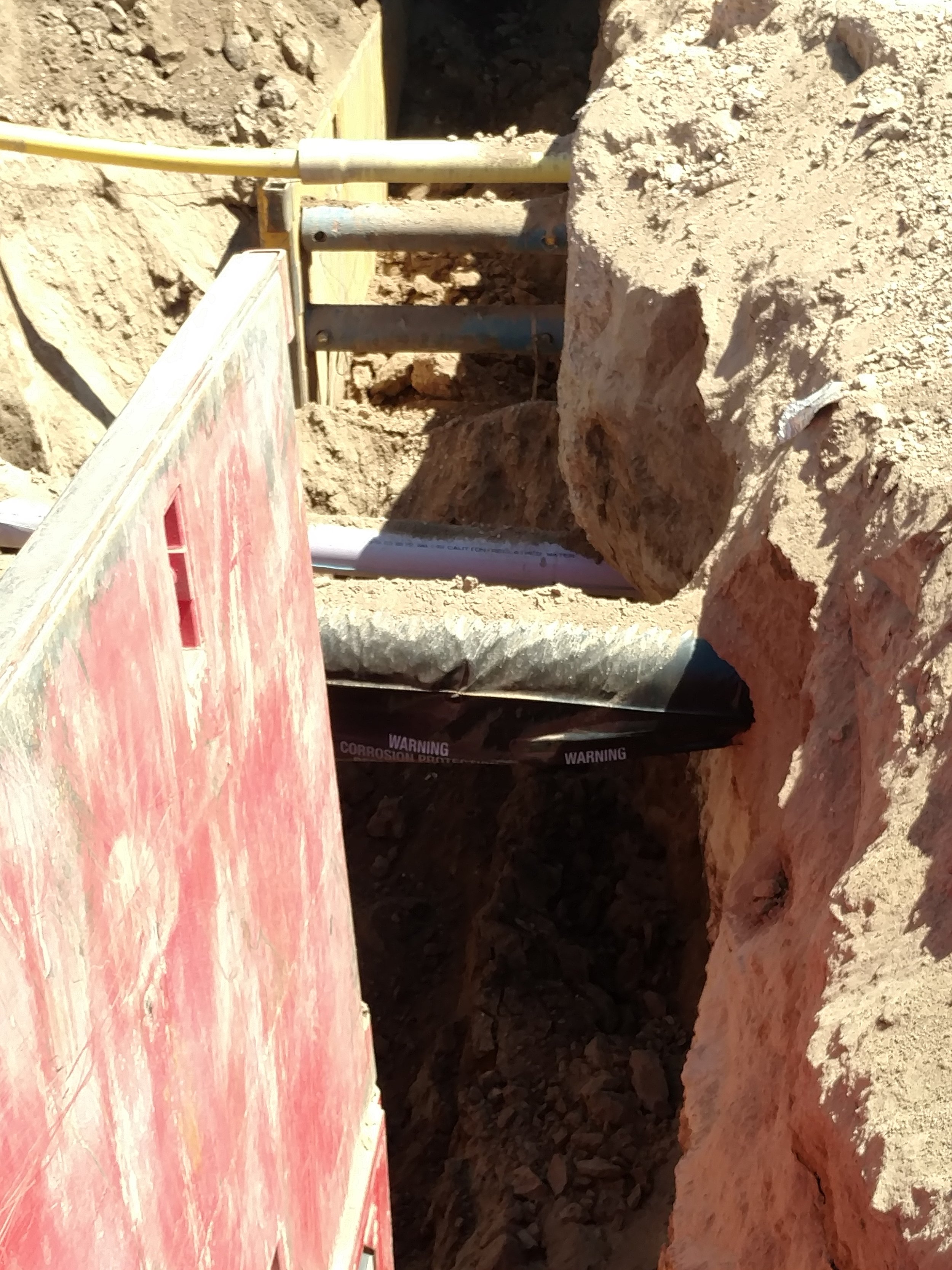 Crossing the sewer line under existing utilities