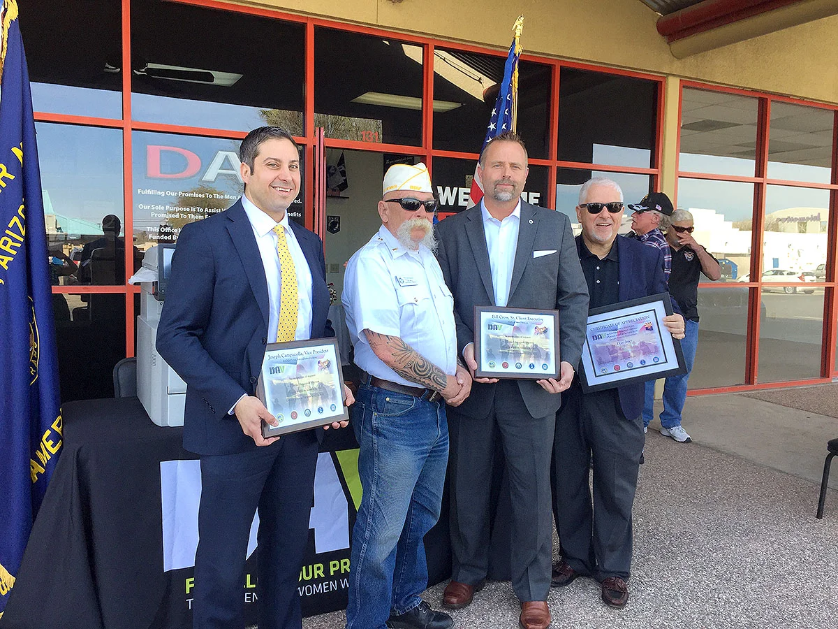 Representatives from Ricoh and the Tucson Disabled American Veterans pose for a photo during the ceremony to celebrate the donation of 15 printers.