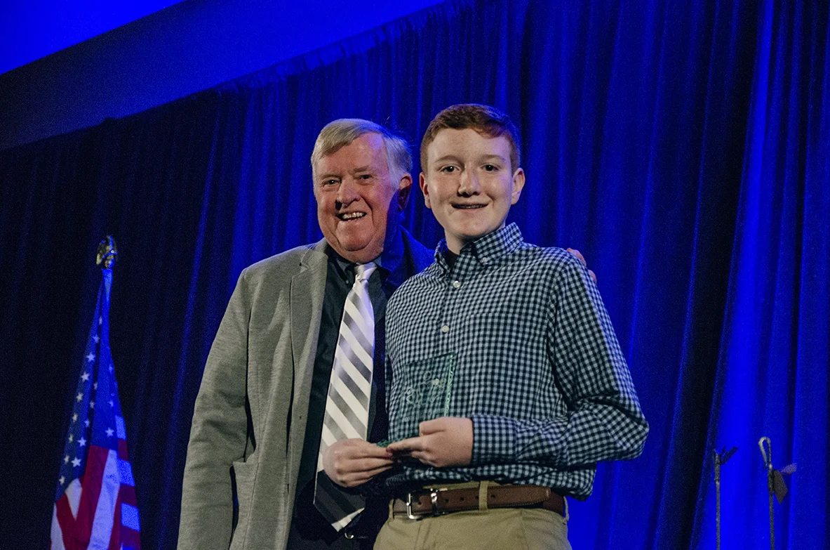 Jacob Cox accepts the Youth Legacy Award from Mayor Honea on the 2019 State of the Town stage.