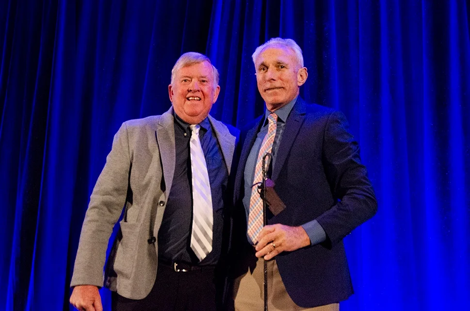 Ed Stolmaker receives the Branding Iron Award from Mayor Honea on the 2019 State of the Town stage.
