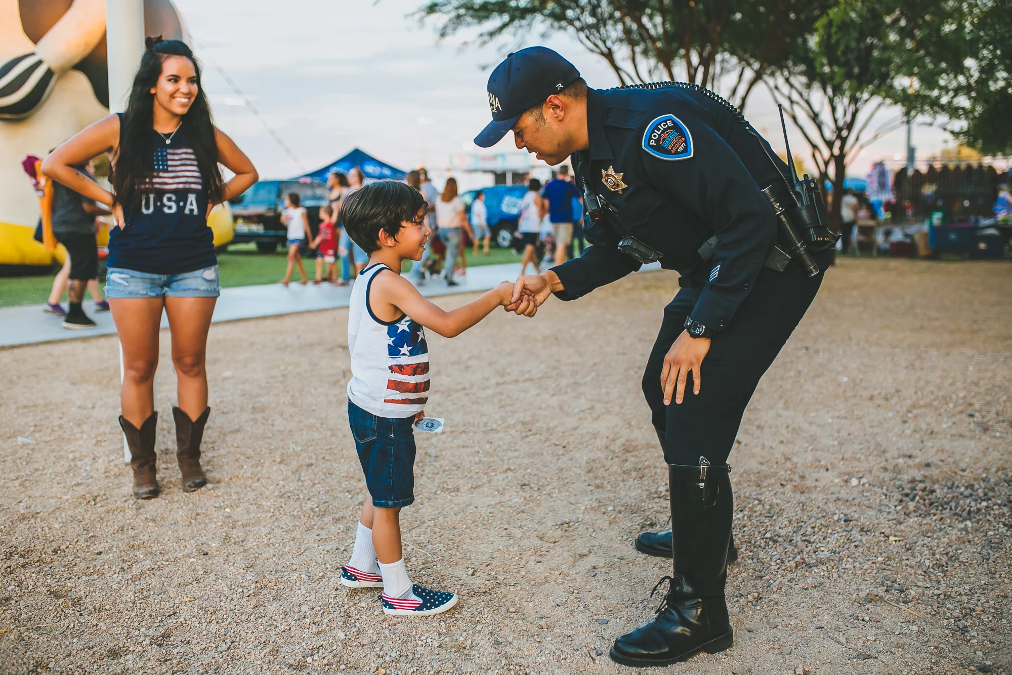 Police officer greeting child at Star Spangled Spectacular