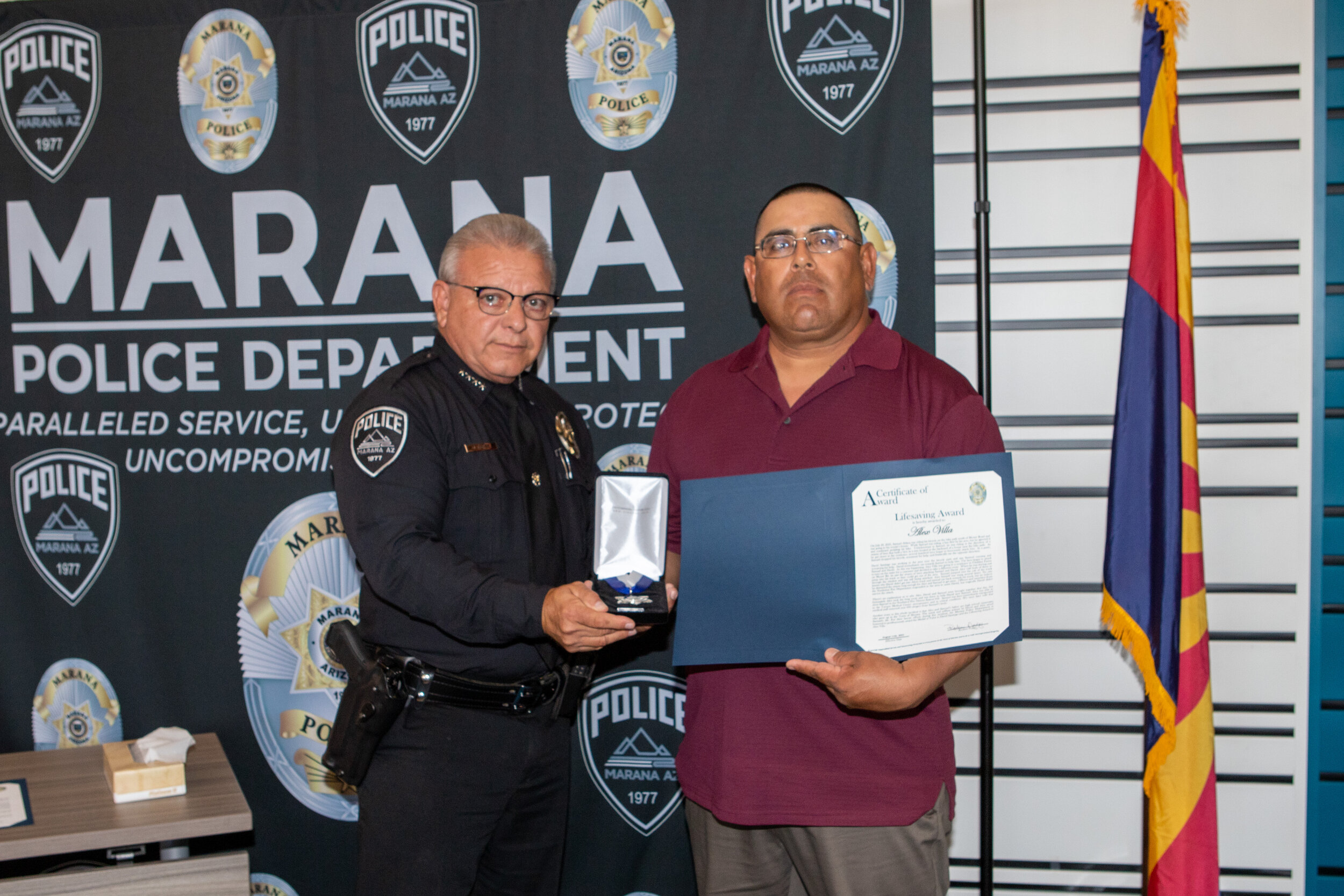 Police Chief Nuñez (left) presenting Lifesaving Award to Alex Villa (right)