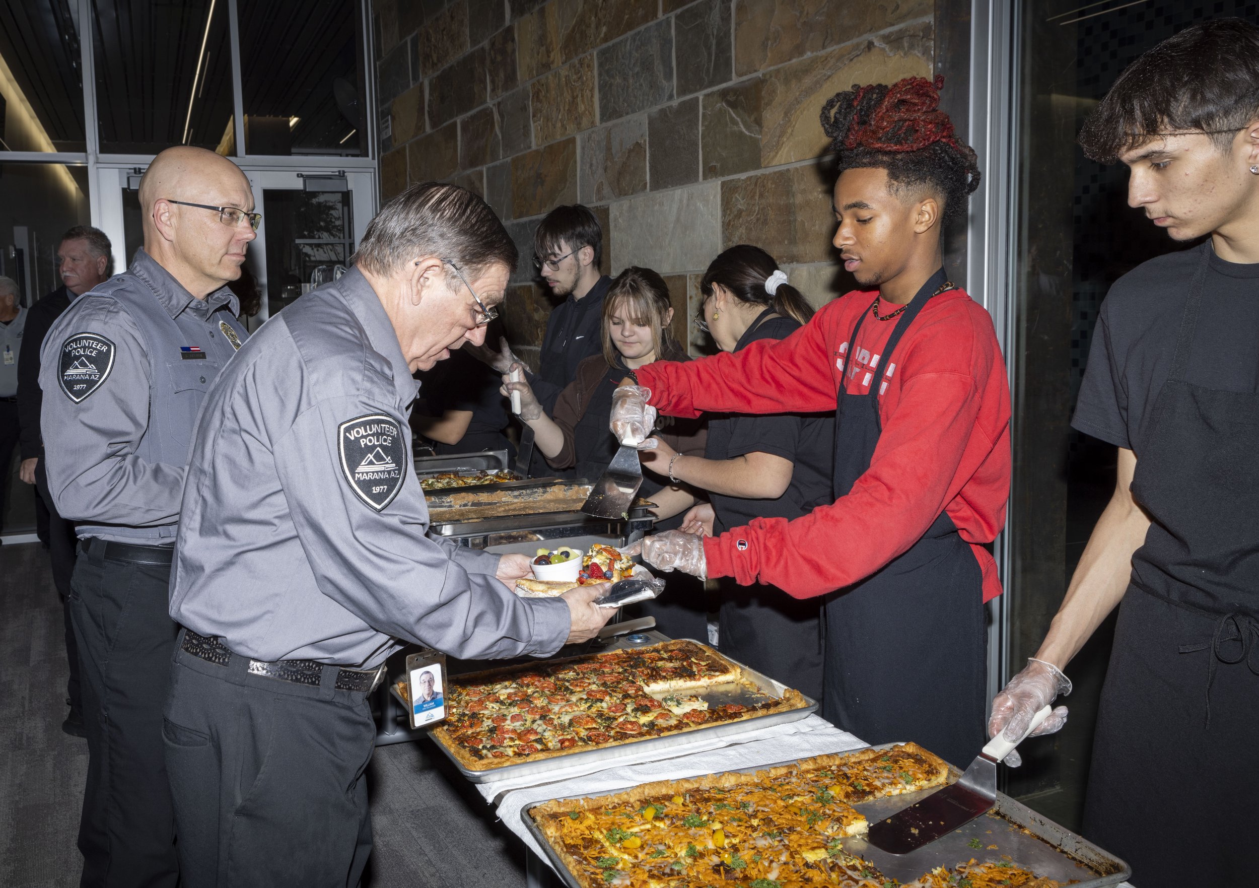 Marana High School students serving police volunteers