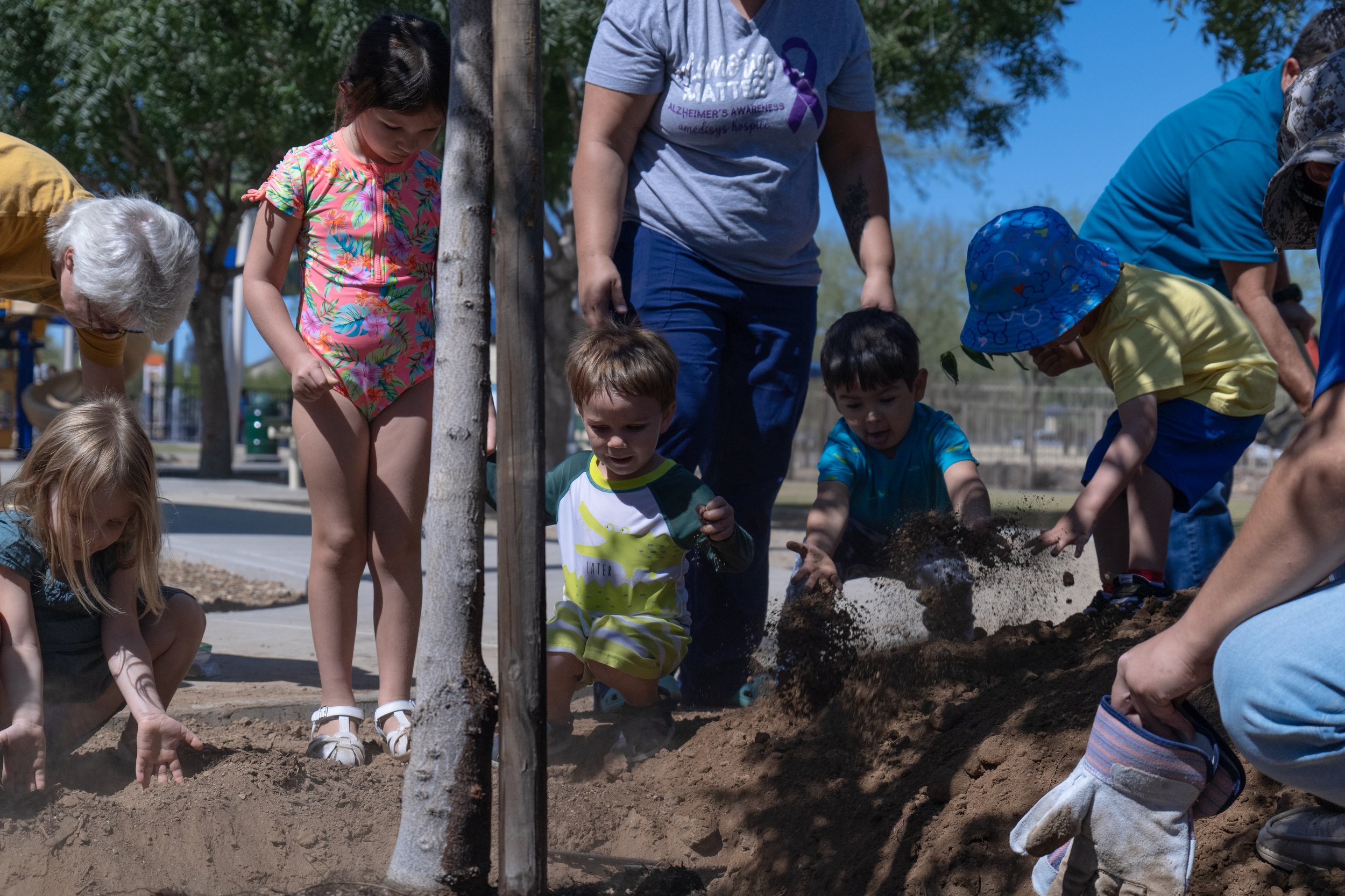 Kids help plant new trees at Crossroads park