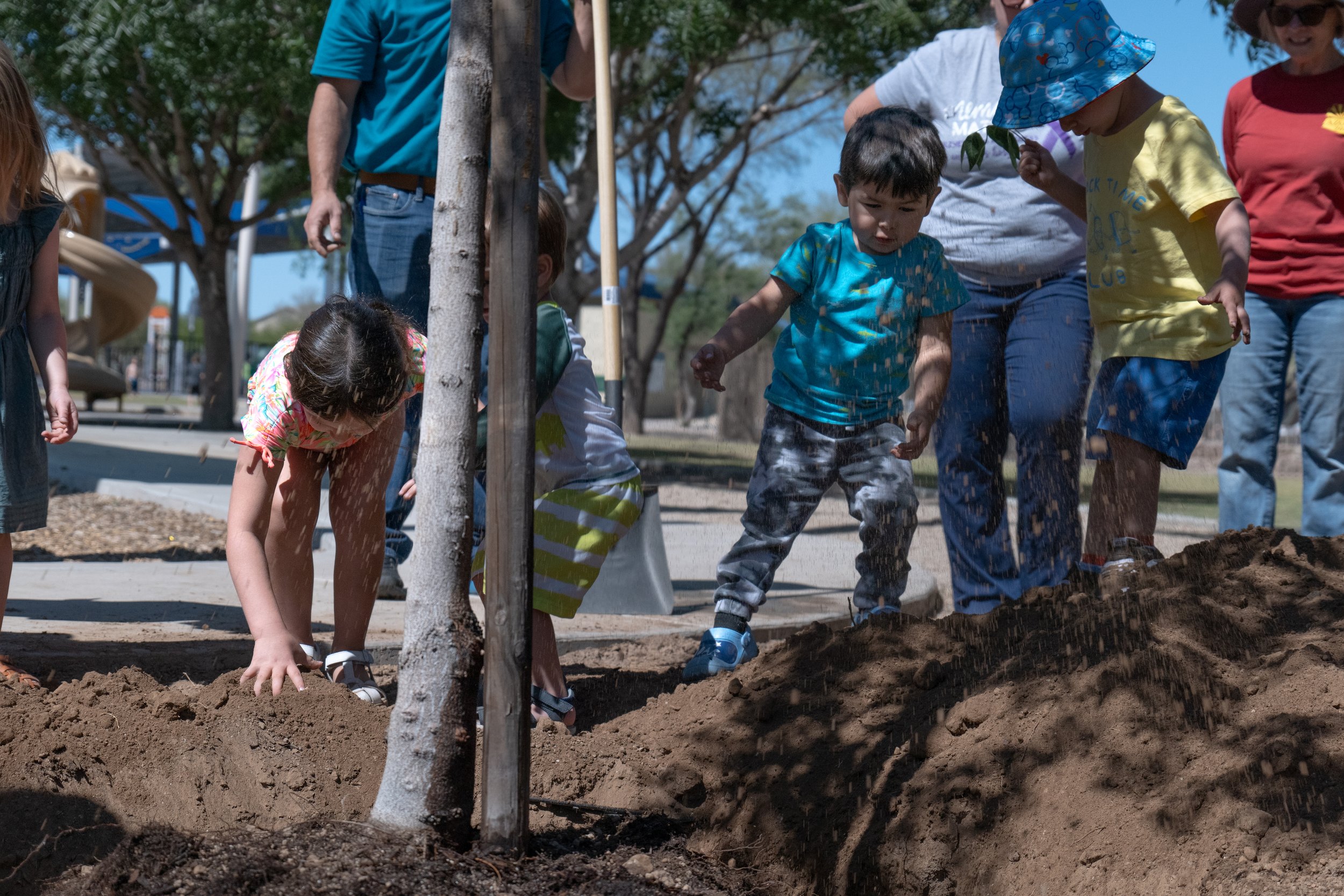 Kids planting new trees at Crossroads Park