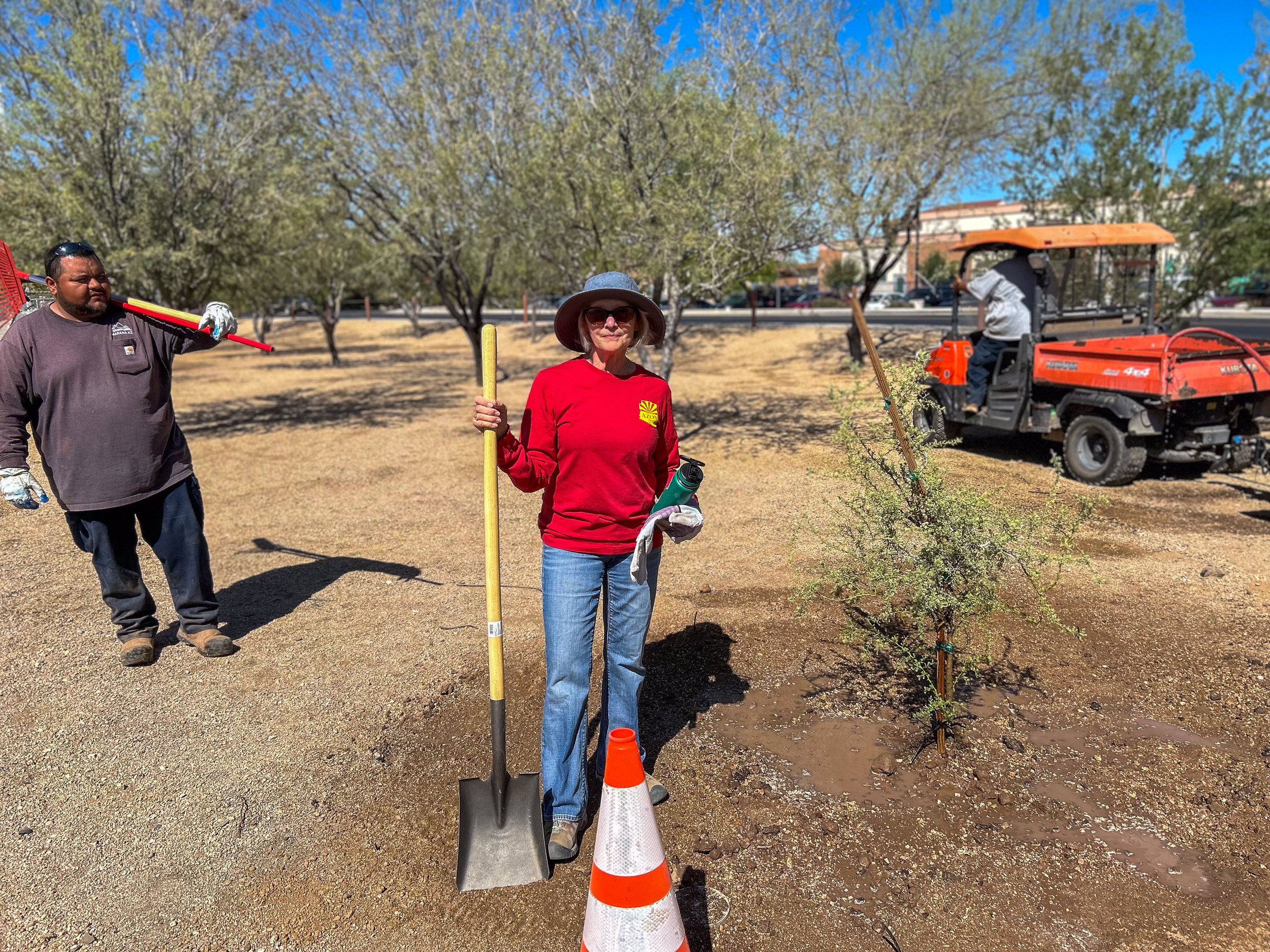 Volunteer planting tree at Crossroads Park