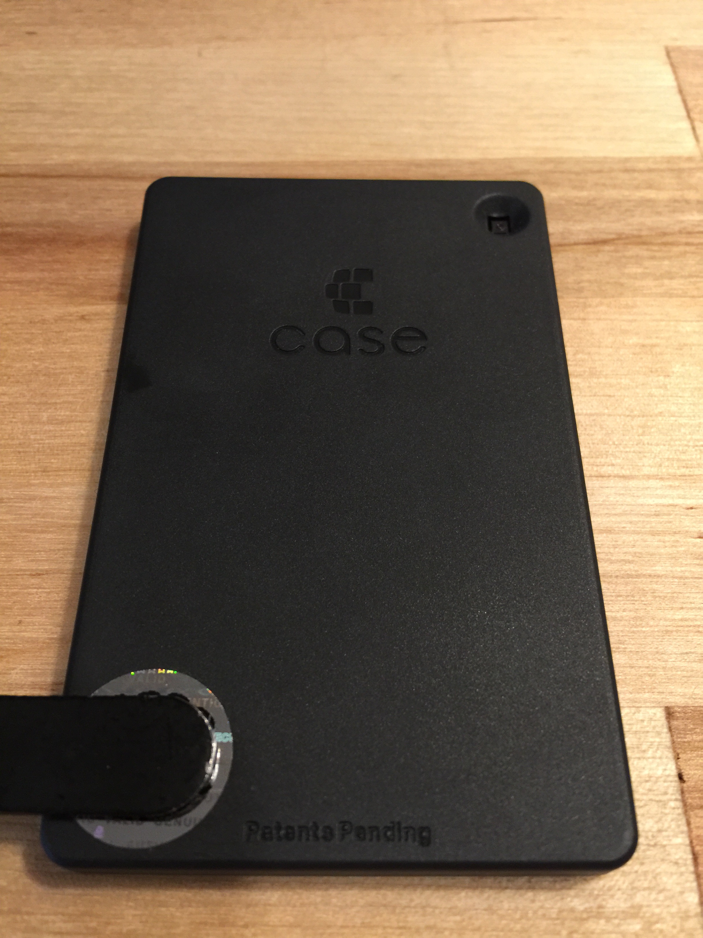 Wobbles when setting on its face due to face button design. Covering hologram sticker with serial number. Generic hologram sticker could be purchased by anyone inexpensively. Why do companies add these useless things?