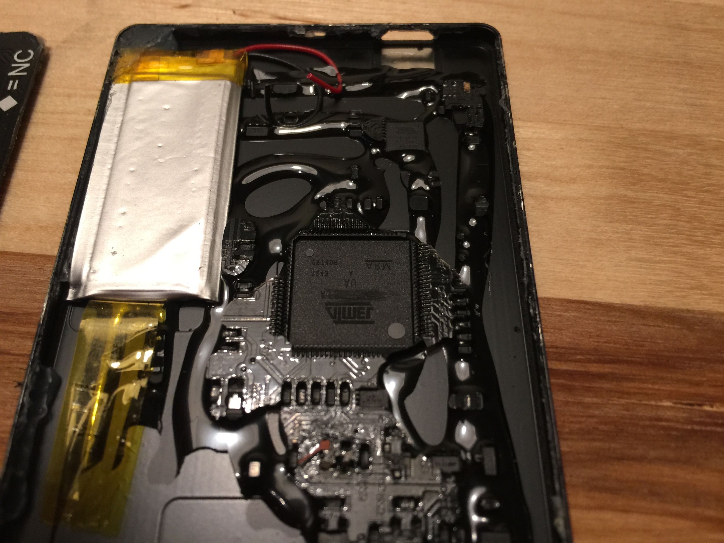 SMT components embedded in hardened black epoxy