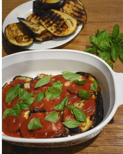 Eggplant Parmigiana showing the layering process.png