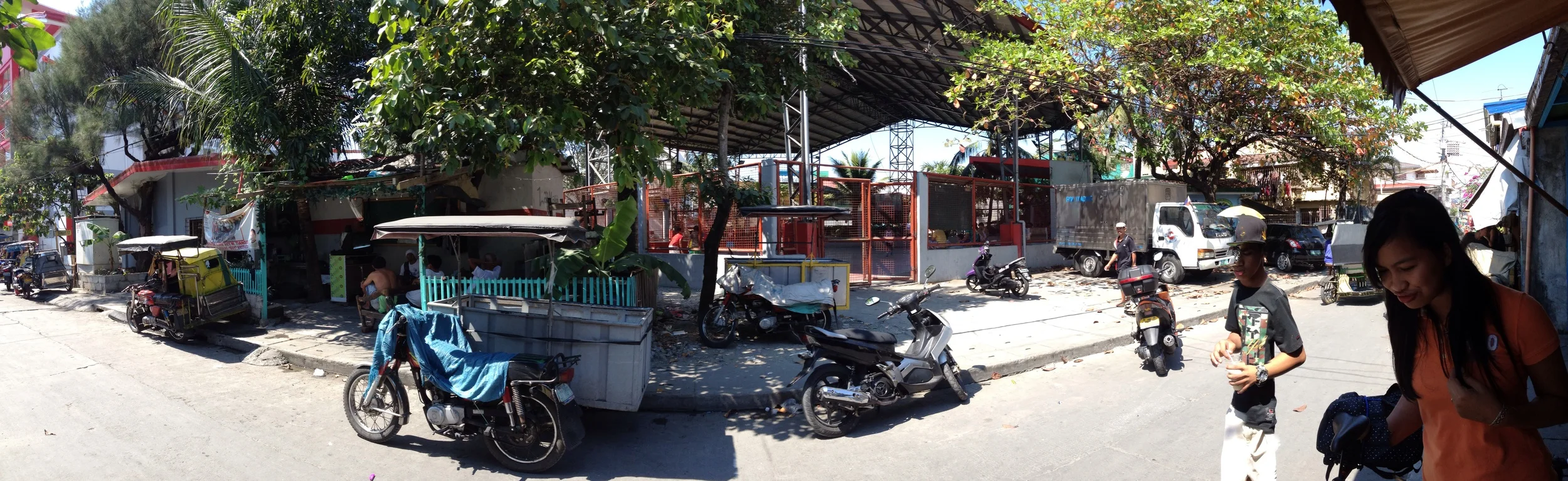 From left to right: barangay hall, tricycle association office, basketball court, day care center 