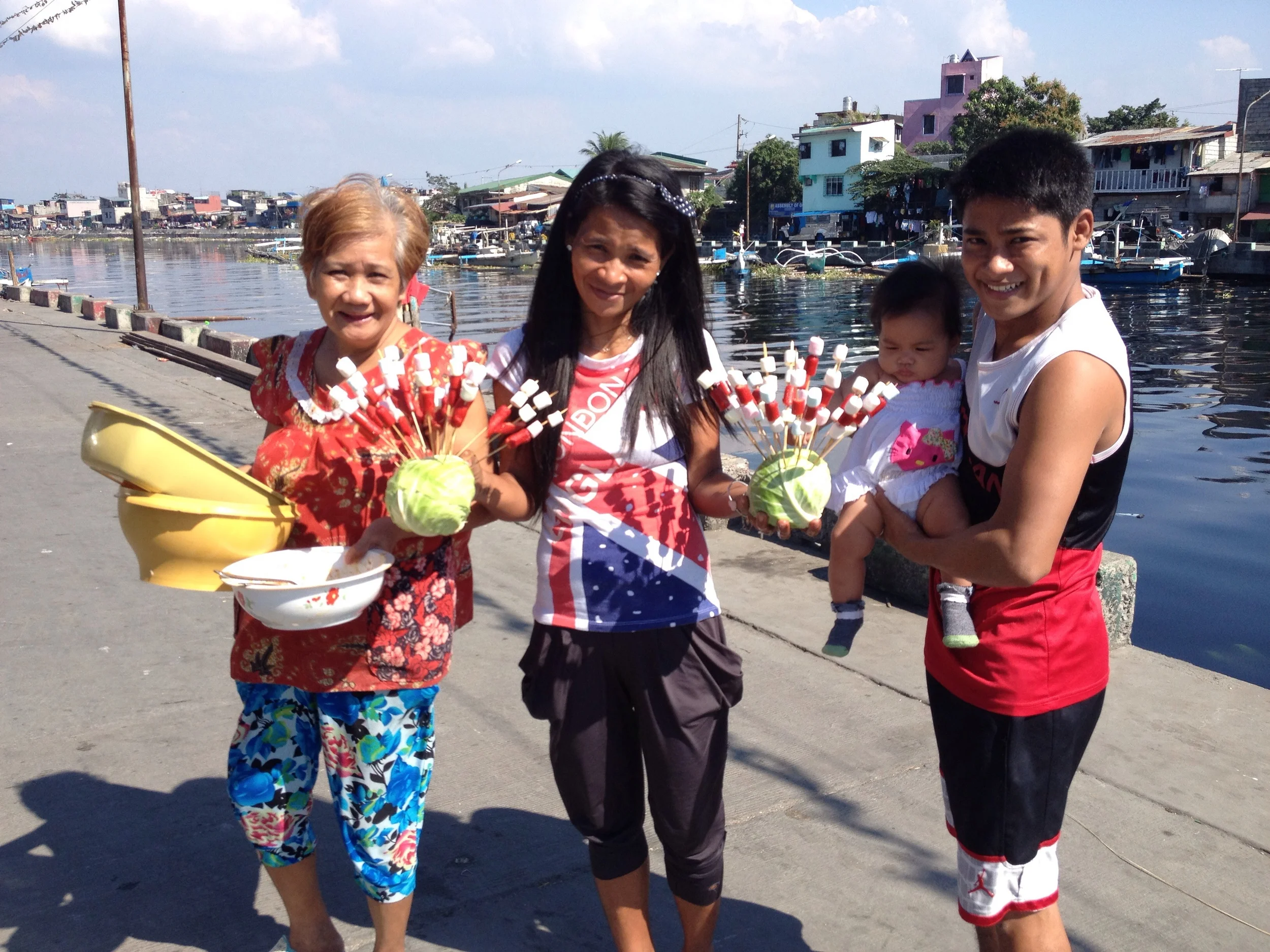 Here's her grandmother, godmother, and cousin bringing food and dishes to and from their house nearby. 