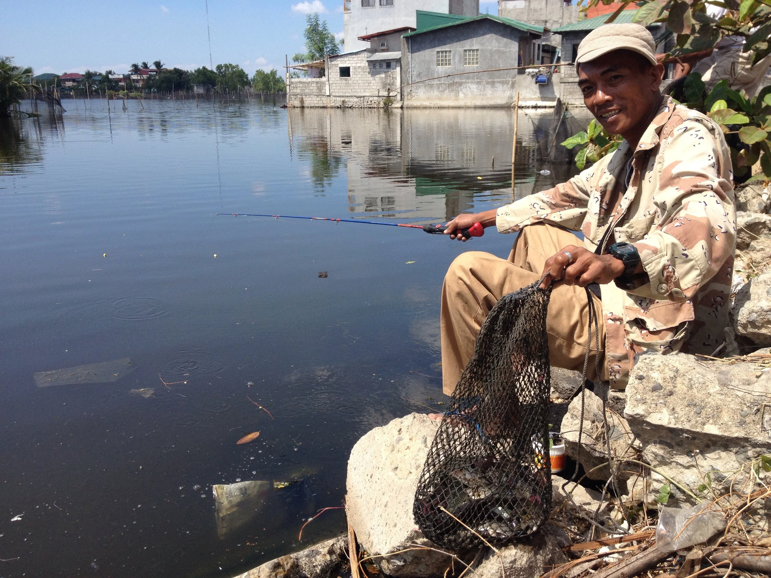 Rhonel, a fisherman from Malabon who bikes to Coloong to catch tilapia for his family. 