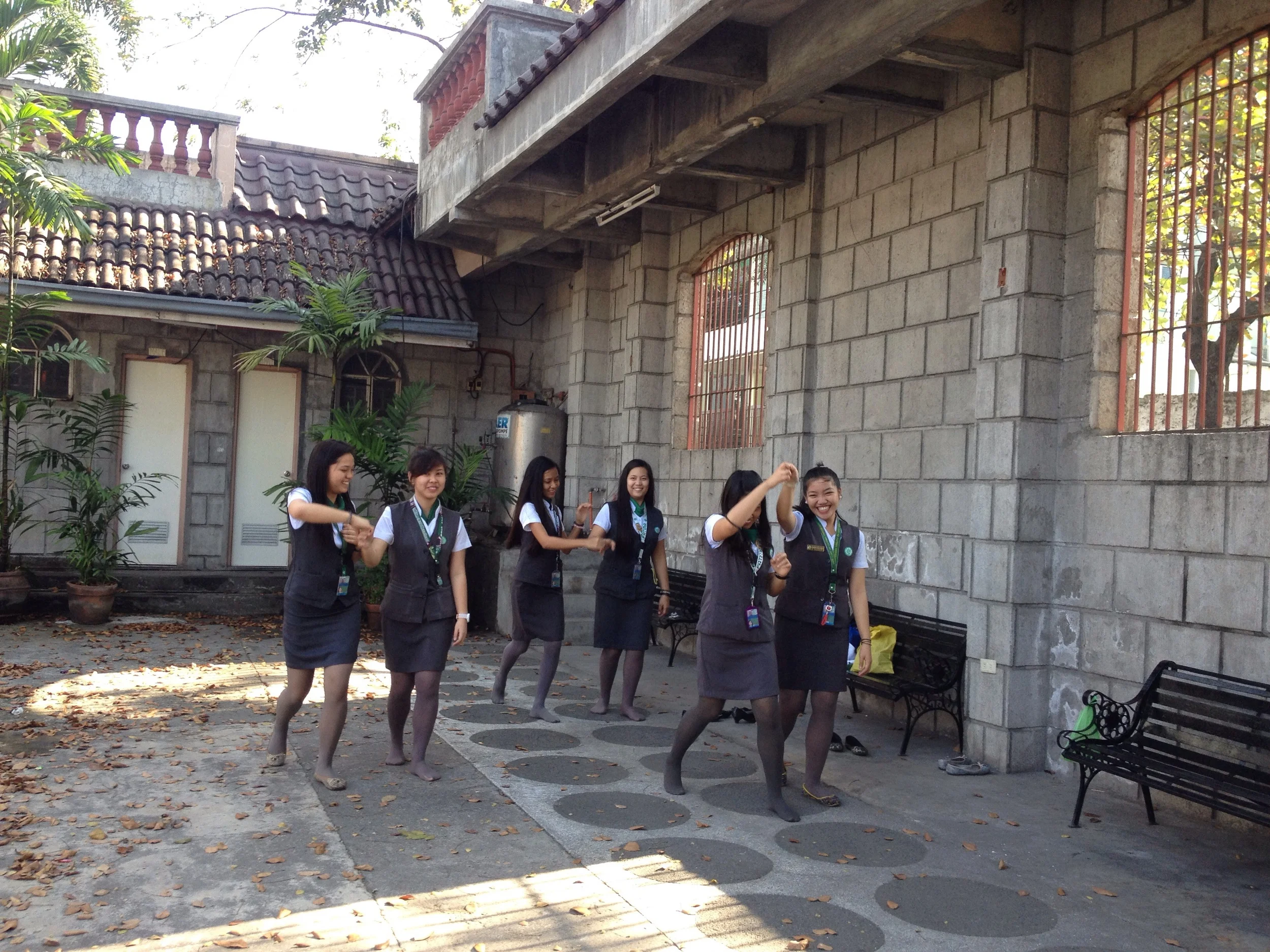 The courtyard outside the museum is used by local students to practice dance moves for a school event. 