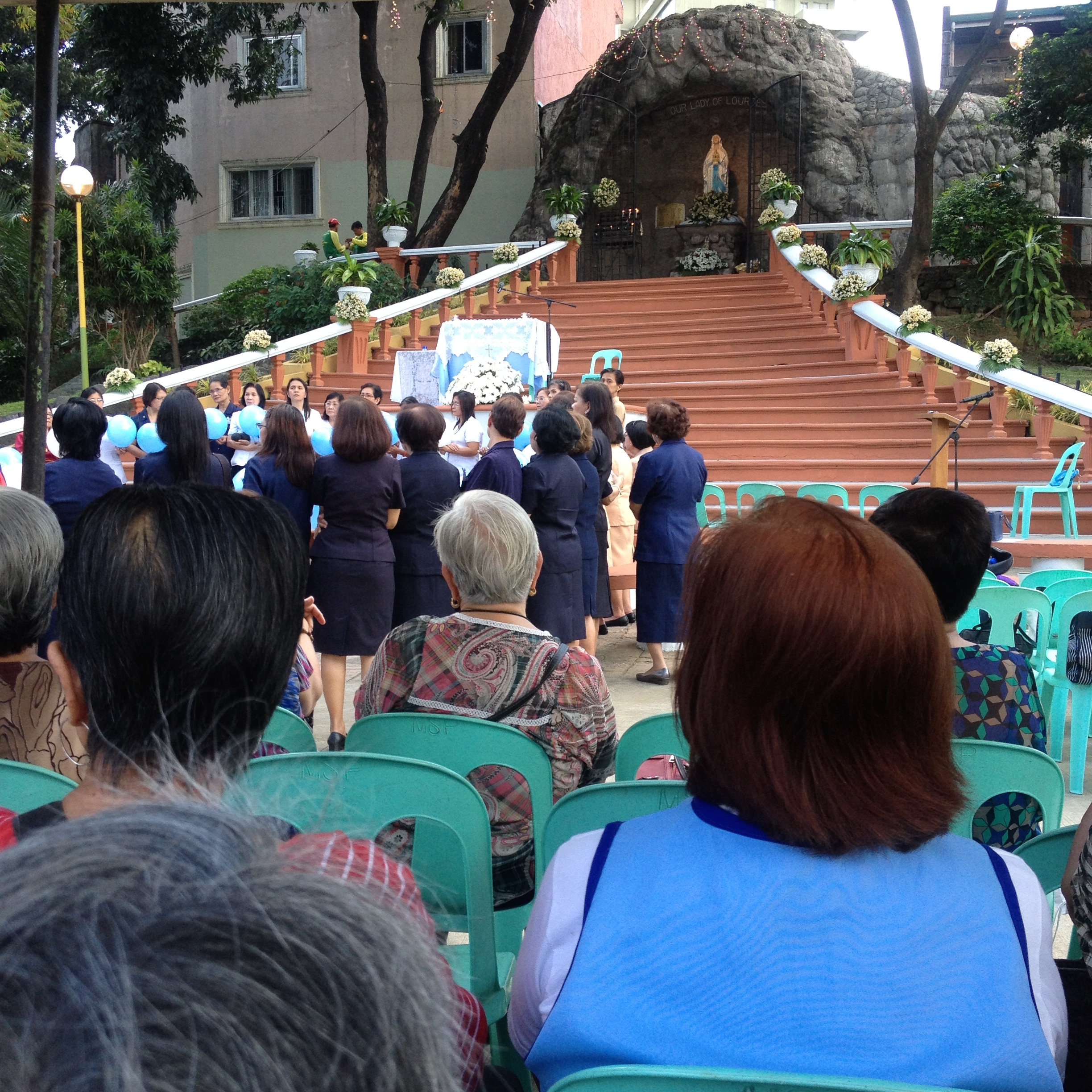 The Feast of Our Lady Lourdes is celebrated with an afternoon mass in front of a large grotto along the river. 