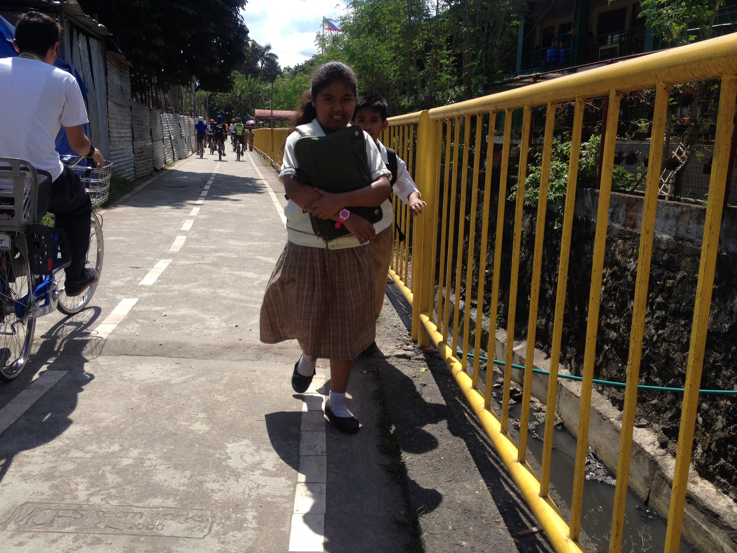 The bike lanes run along esteros in the city. The water seems relatively clean and does not smell. The lanes connect schools like this one (at the right) to residential areas. In Marikina the bike lanes are not arbitrary, but actually link social uses. 